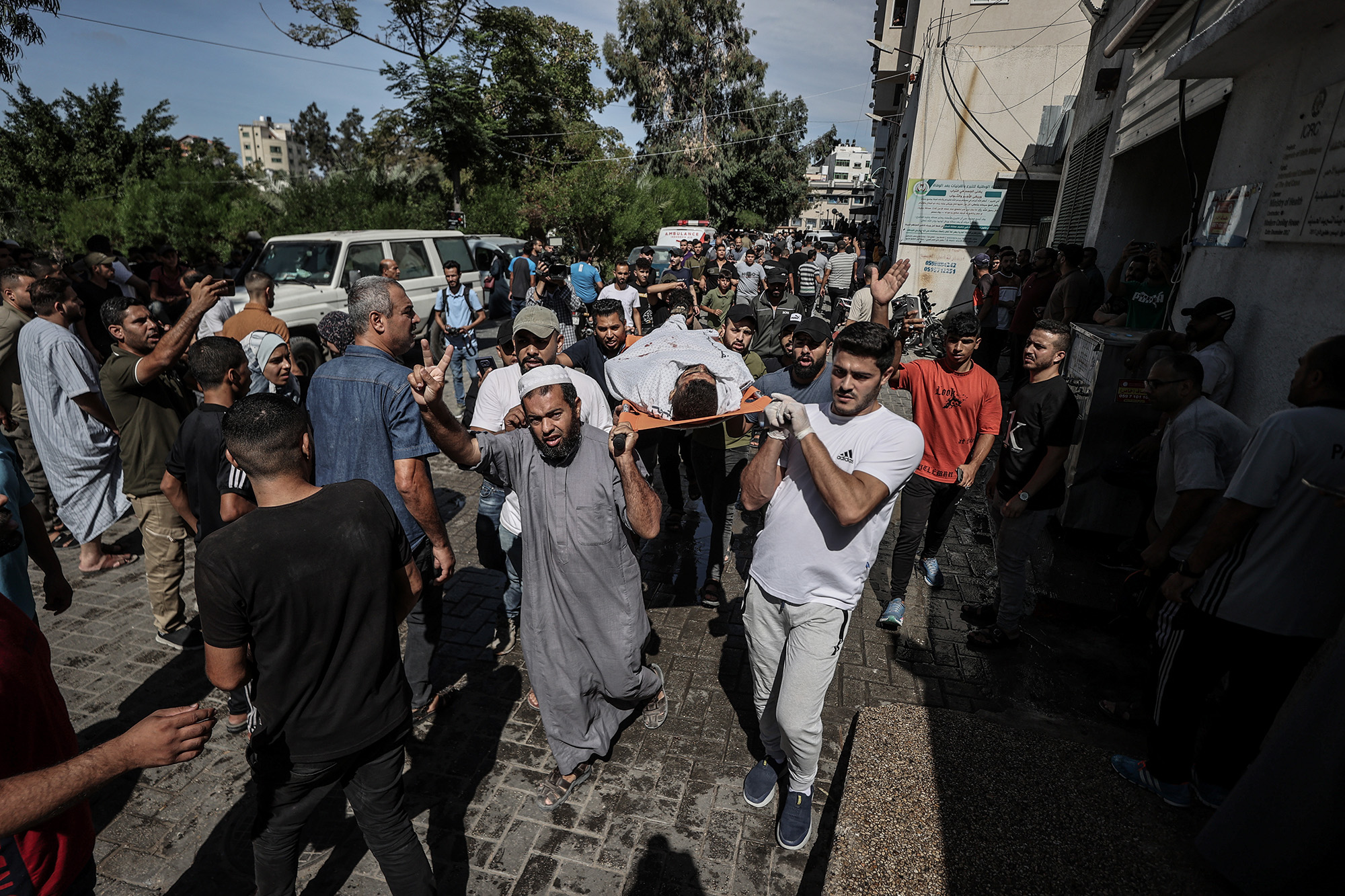 Bodies of Palestinians killed in airstrikes are taken to the morgue at Shifa Hospital in Gaza City, Gaza, on October 7.