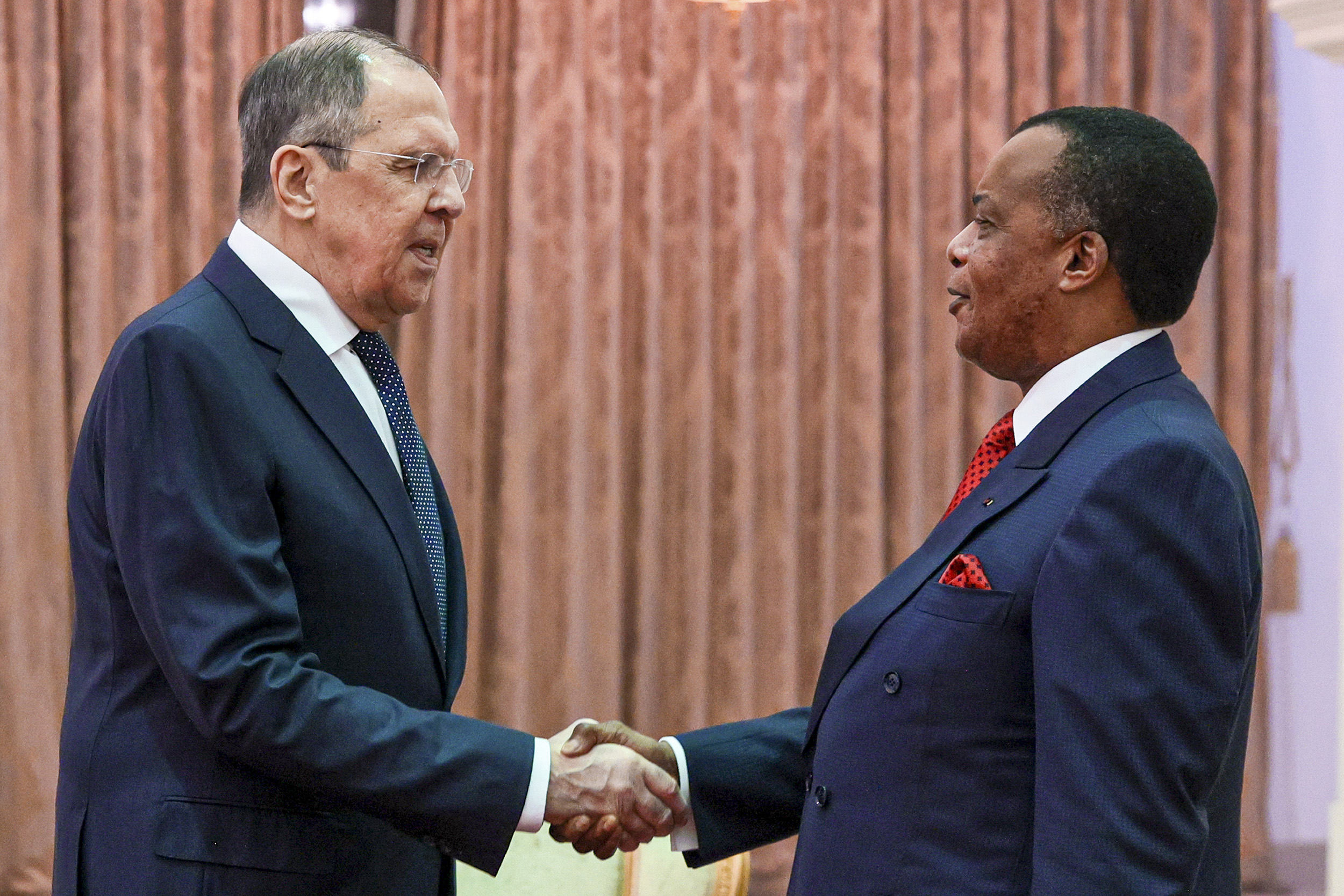 Congolese President Felix Tshisekedi, right, and Russian Foreign Minister Sergey Lavrov, left, shake hands prior to their talks in Brazzaville, Congo, on July 25.