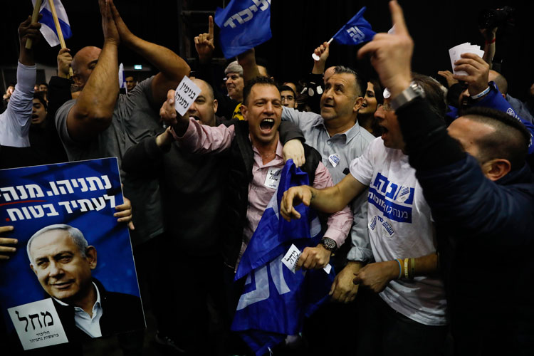 Israeli Prime Minister Benjamin Netanyahu's supporters celebrate first exit poll results for the Israeli elections at his party's headquarters in Tel Aviv.