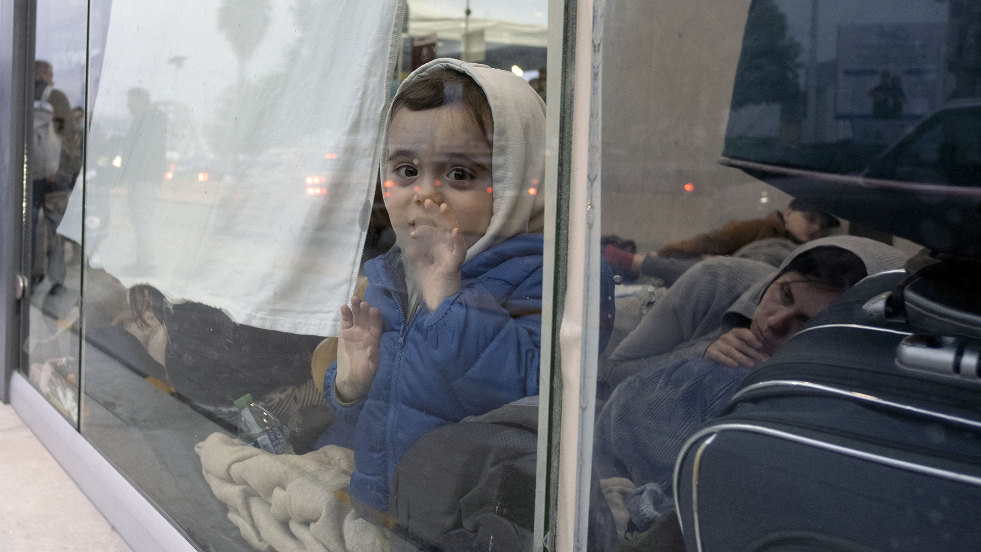 A Ukrainian child seeking asylum in the United States is seen inside a bus station on the Mexican side of the San Ysidro crossing port in Tijuana, Mexico on April 2.