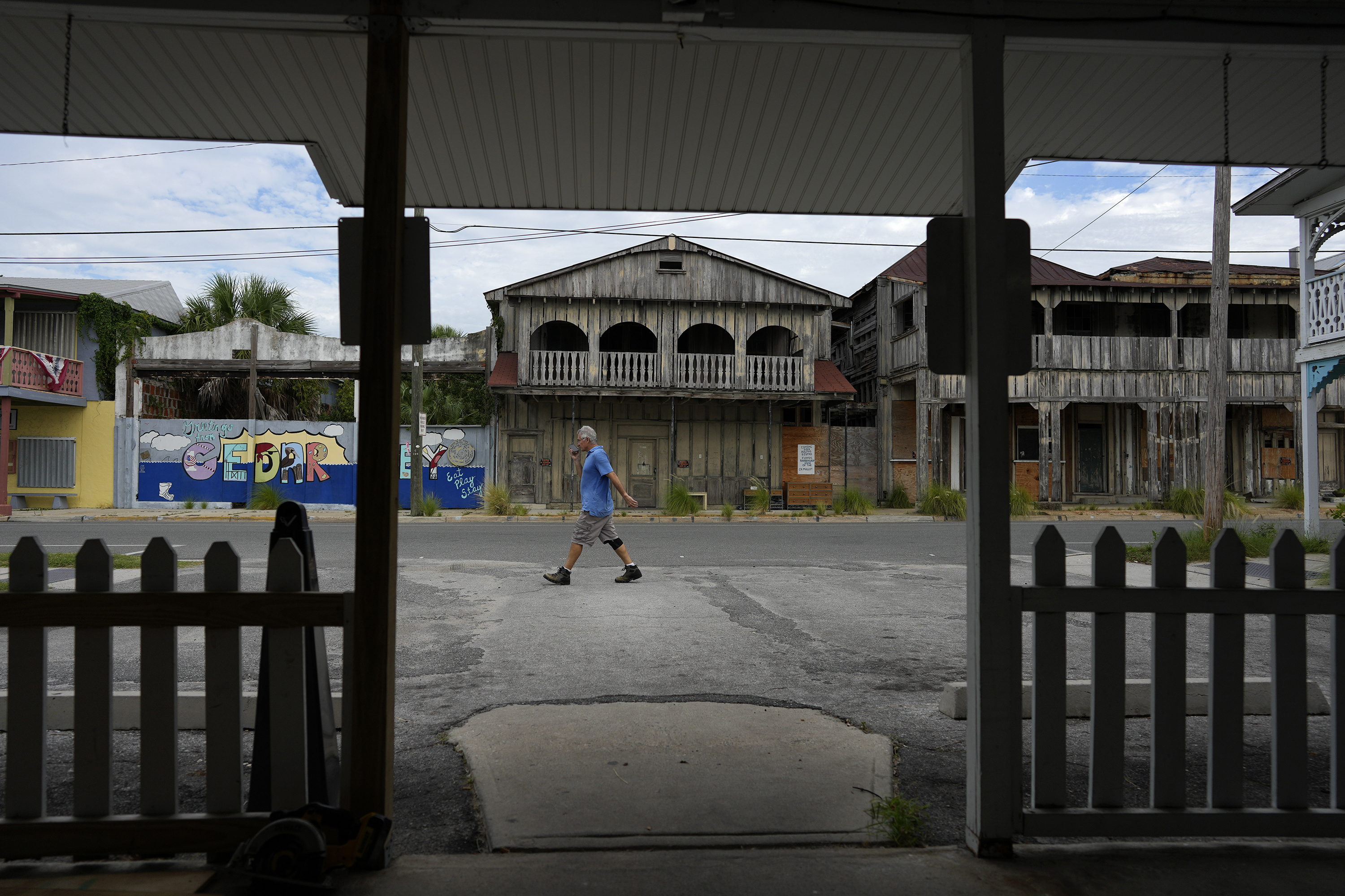 A man walks by, where businesses and residents were preparing for potential flooding, ahead of the expected arrival of Hurricane Idalia in Cedar Key, Flaorida, on August 29.