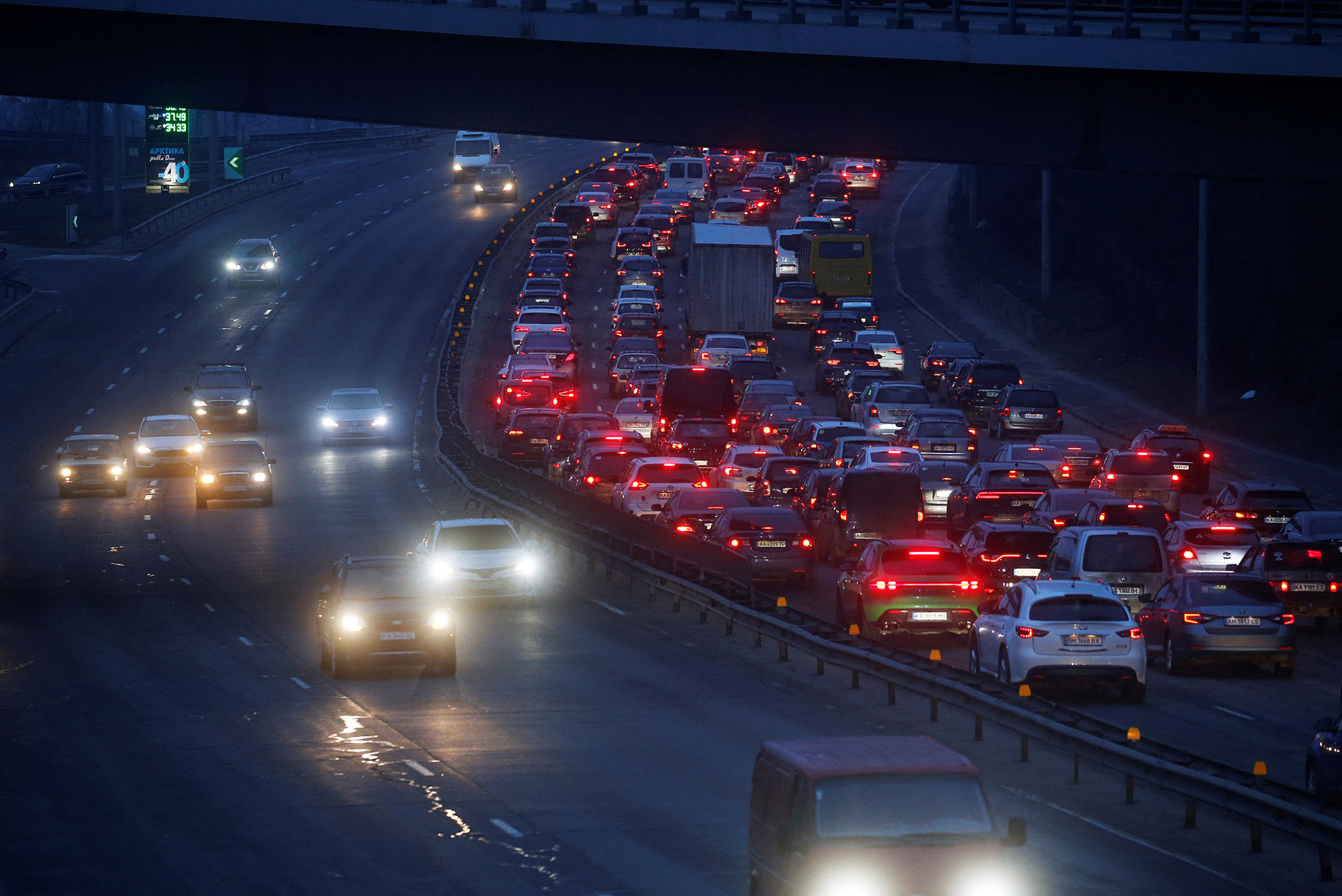 A long line of cars is seen exiting Kyiv on February 24. Heavy traffic appeared to be heading west, away from where explosions were heard early in the morning.