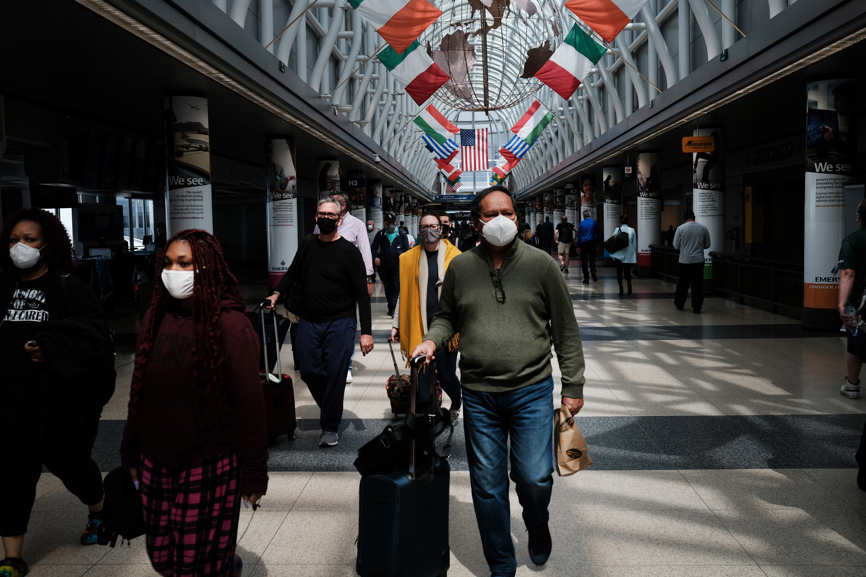 People walk through Chicago O’Hare airport on April 26 in Chicago.