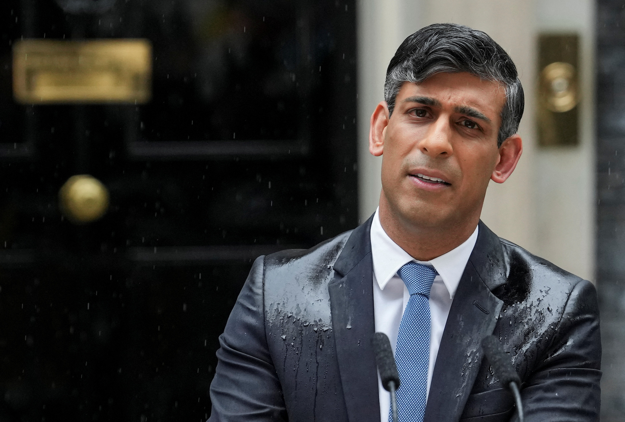 British Prime Minister Rishi Sunak delivers a speech in the rain on Wednesday.