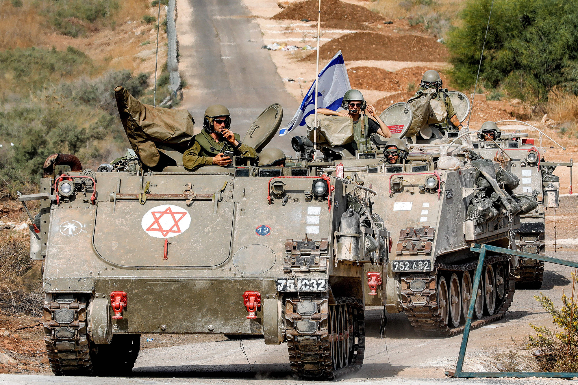 Israeli army tracked vehicles move along a road near the northern town of Kiryat Shmona close to the border with Lebanon on October 31.
