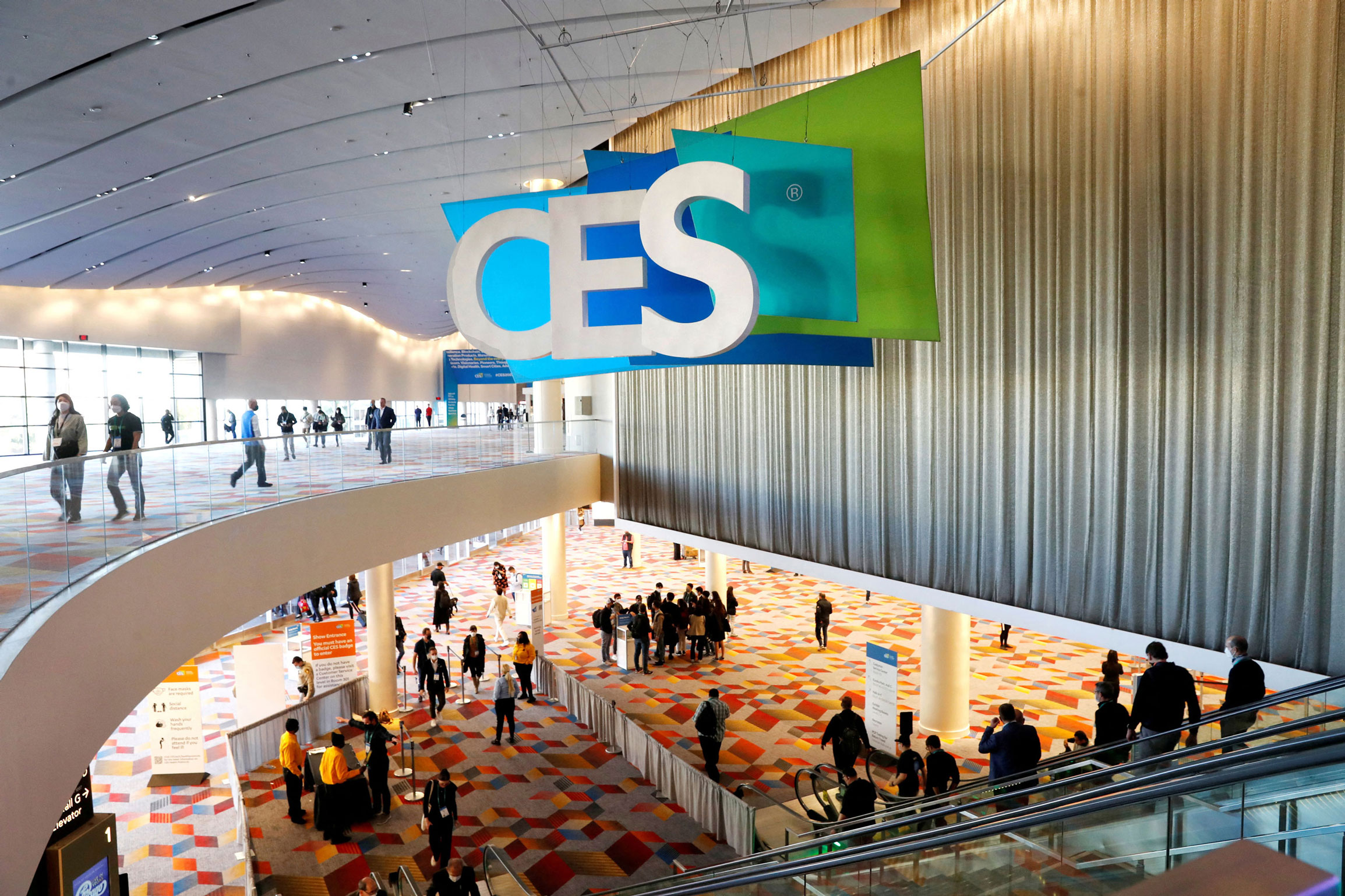 Attendees walk around the entrance of CES 2022 in Las Vegas on January 6.