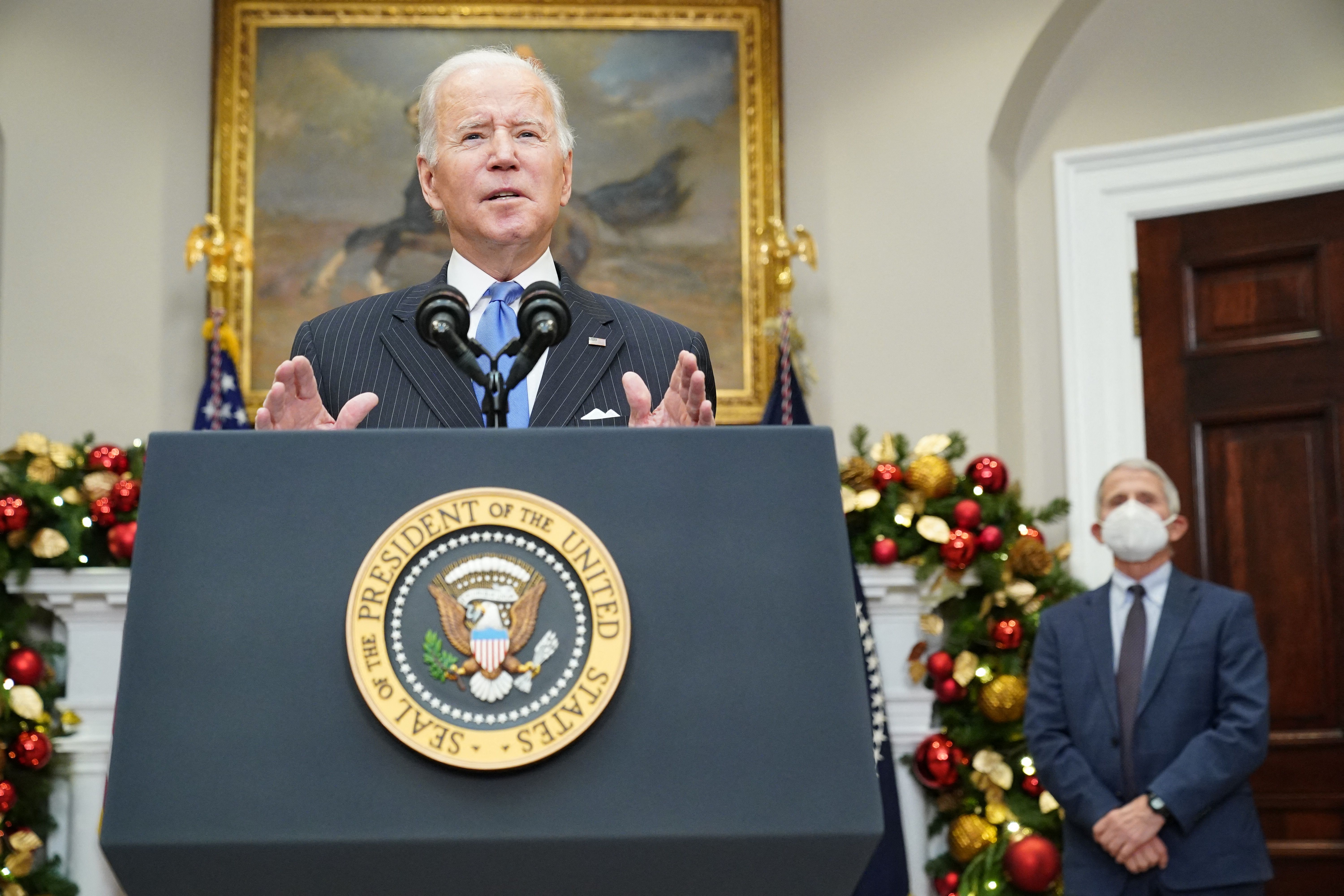 United States President Joe Biden, standing beside Dr anthony Fauci (R), delivers remarks to provide an update on the Omicron variant in the Roosevelt Room of the White House in Washington, DC on November 29, 2021.