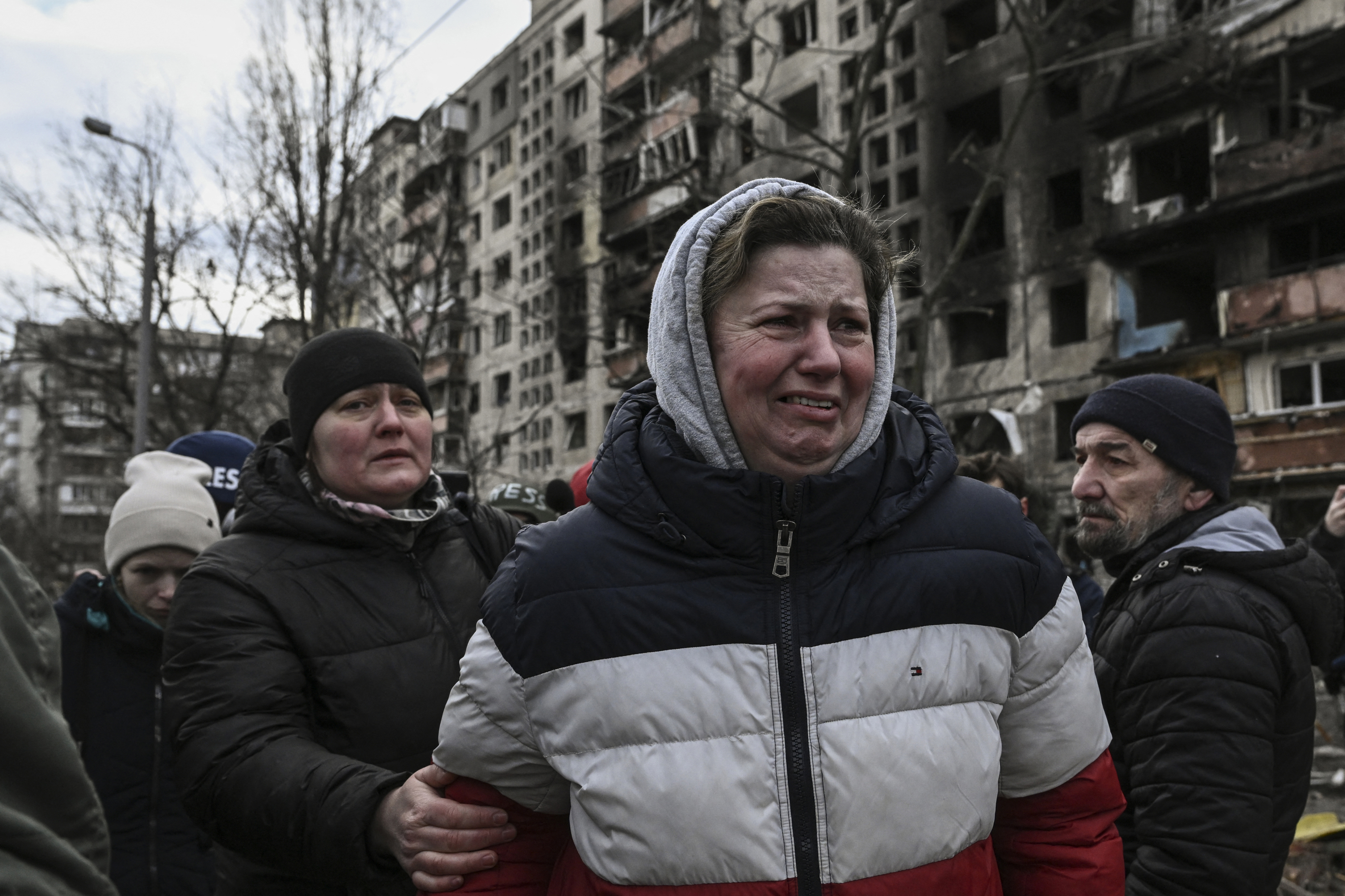 A woman reacts as she stands outside destroyed apartment blocks following shelling in the northwestern Obolon district of Kyiv, Ukraine, on March 14.