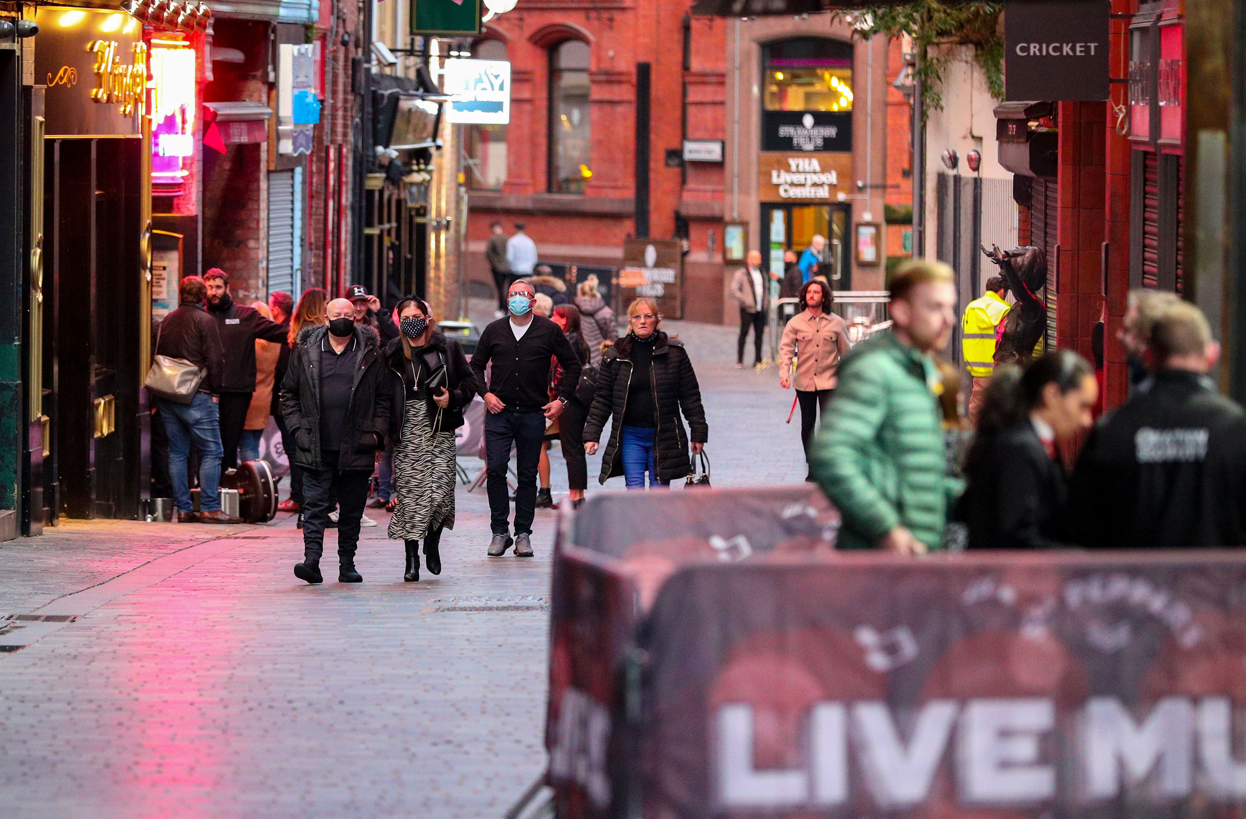 People walk in Liverpool, England, on October 9, ahead of Prime Minister Boris Johnson’s expected announcement of a new three-tier system of coronavirus restrictions.