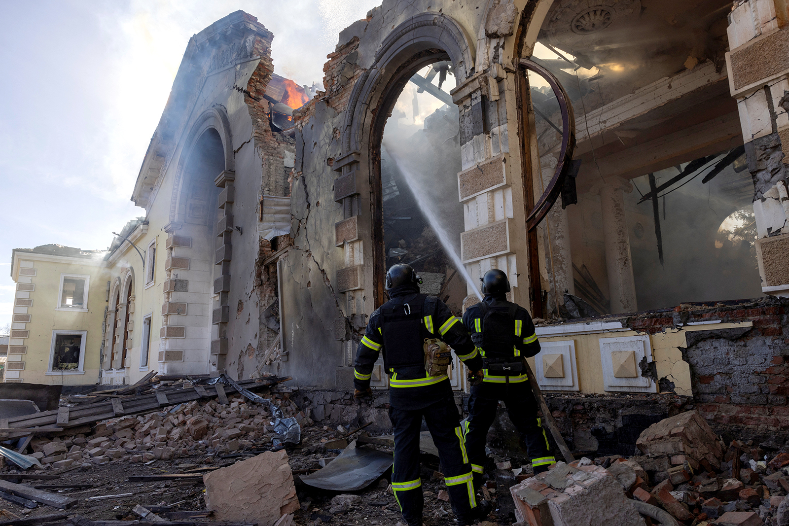 Firefighters work at the scene of a Russian missile strike that destroyed a train station in Kostiantynivka, Ukraine, on February 25. 