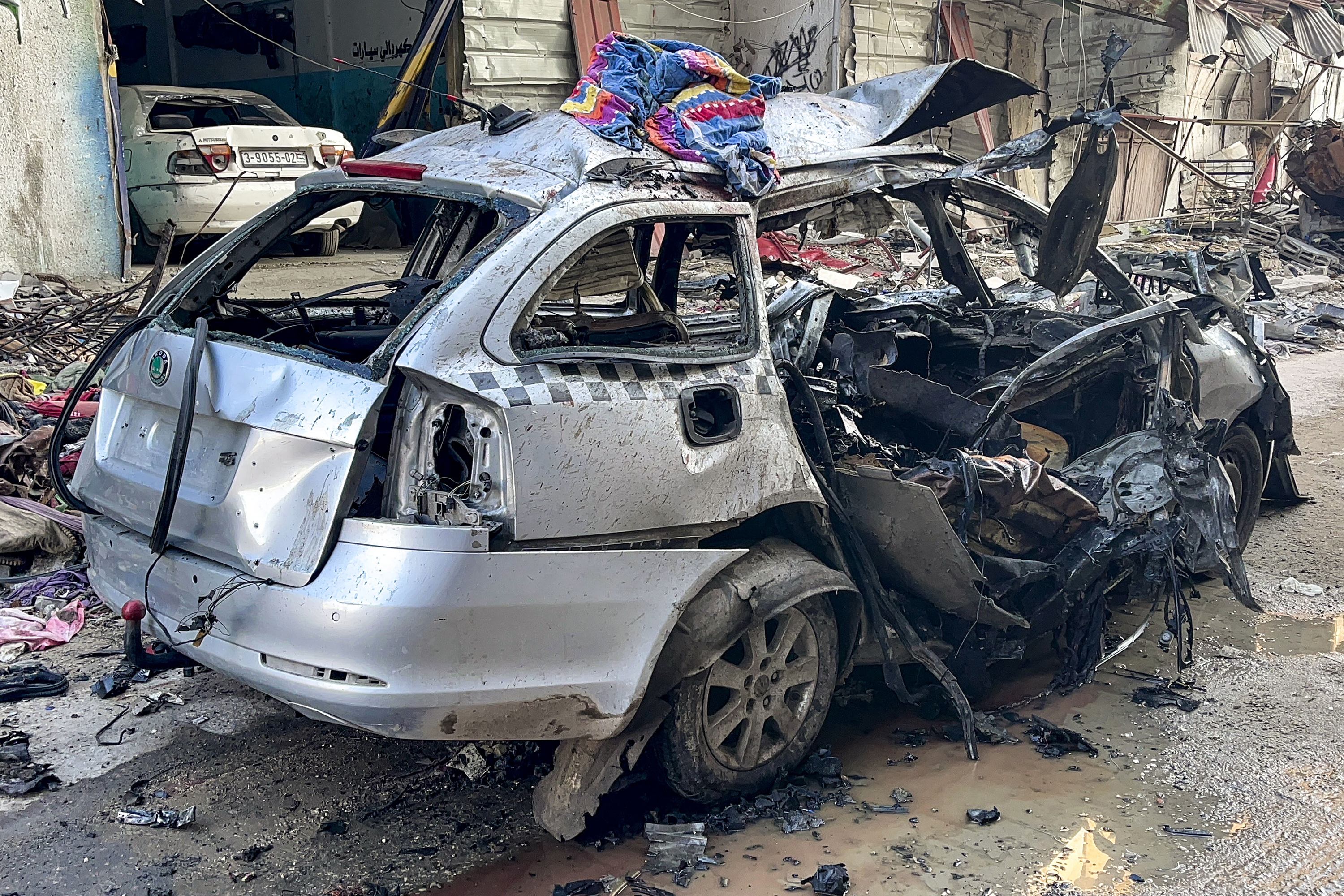 The car in which three sons of Hamas leader Ismail Haniyeh were reportedly killed in an Israeli air strike is pictured near Al Shati, northwest of Gaza City, on April 10.