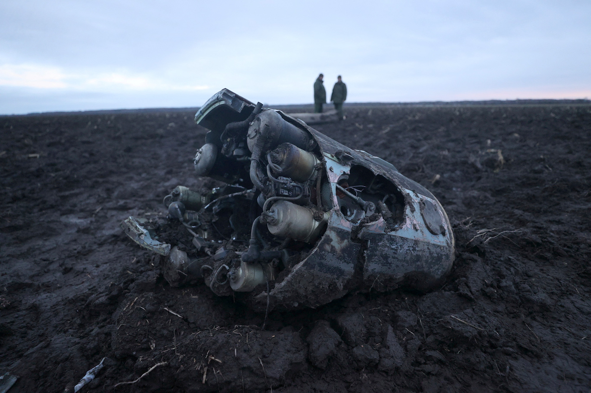 Investigators gather near fragments of a munition downed by Belarusian air defences outside the village of Harbacha in the Grodno region, Belarus, on December 29, 2022. 