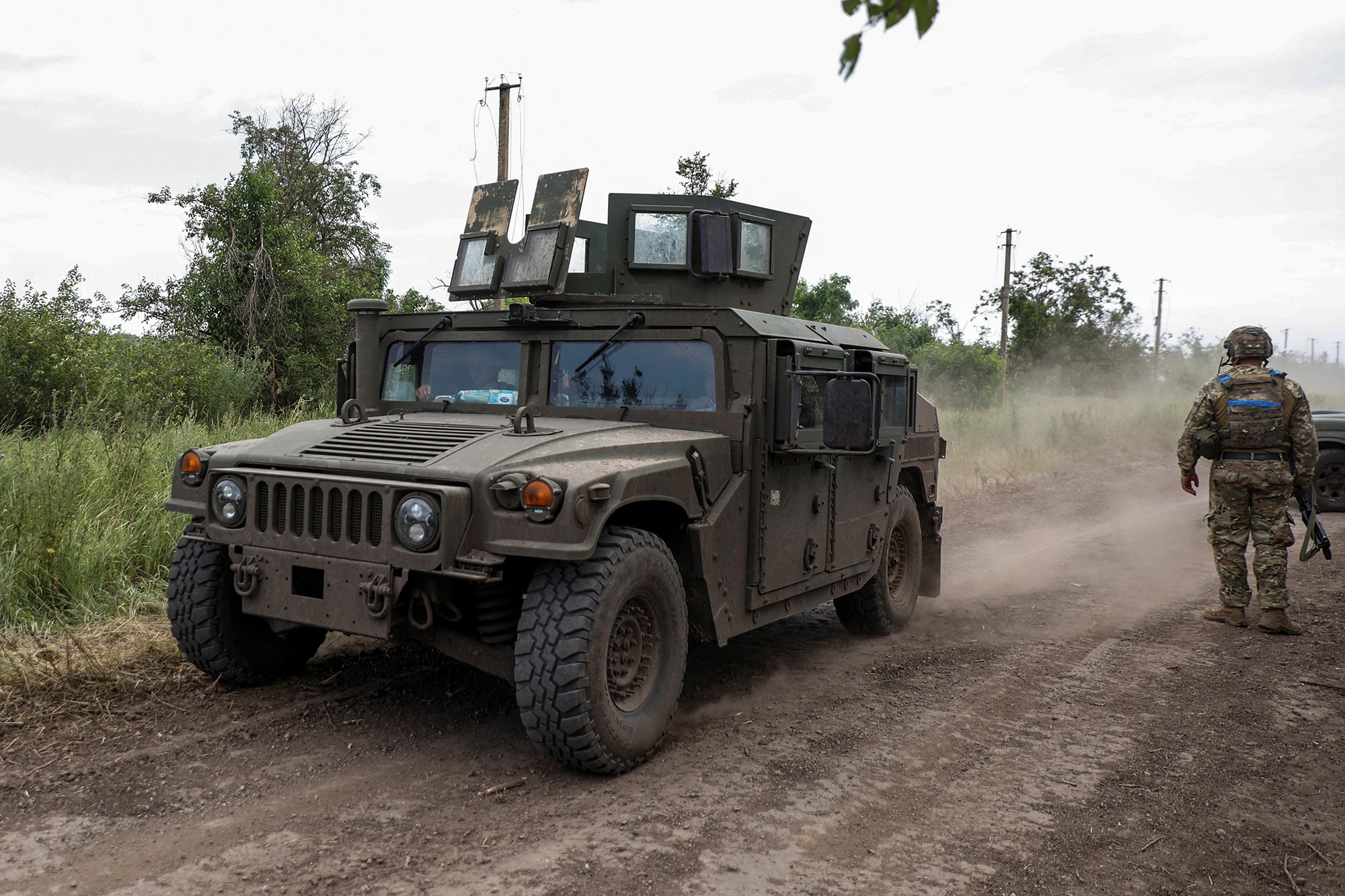 A Ukrainian military vehicle moves along a road near the recently retaken village of Novodarivka in Zaporizhzhia region, Ukraine, on July 2.