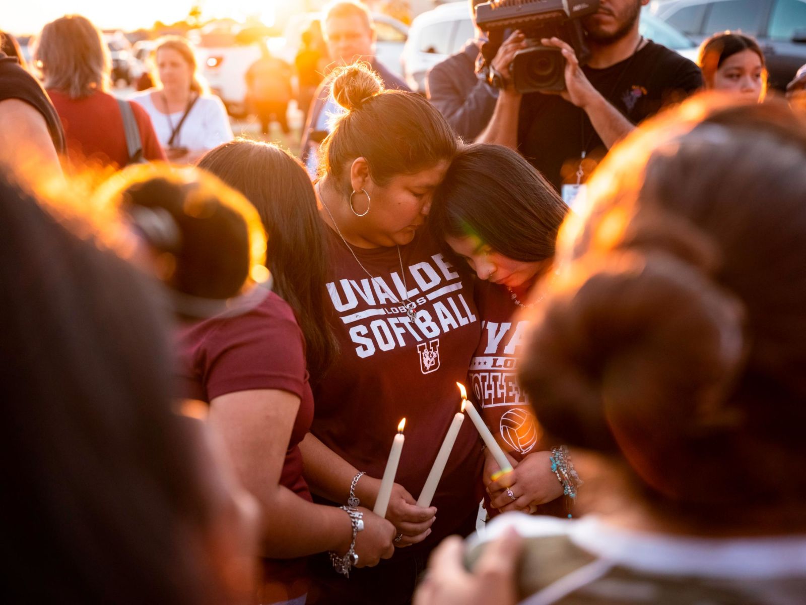 People in Uvalde light candles during a memorial for the shooting victims on Wednesday, May 25. 