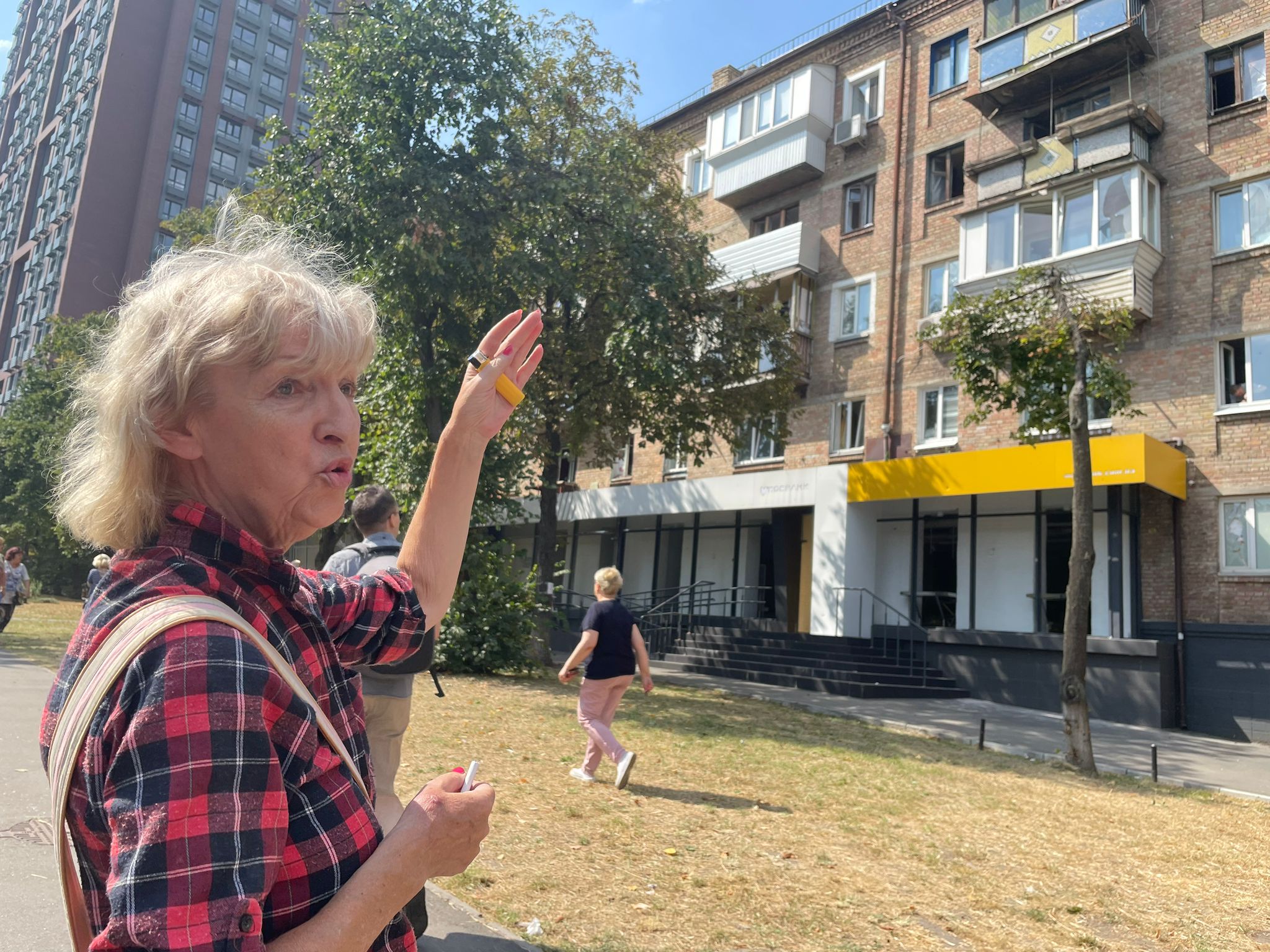 Yelena Yemelyanova, 69 year old retired medical worker, points up at her balcony. The explosion on August 30 blew out her windows and blast wave threw her against a wall.