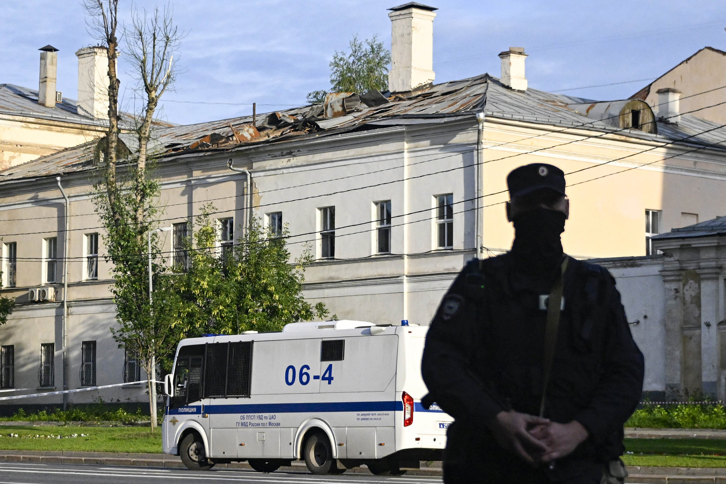 Police secure an area outside a damaged non-residential building on Komsomolsky Prospekt after a reported drone attack in Moscow, on July 24. 