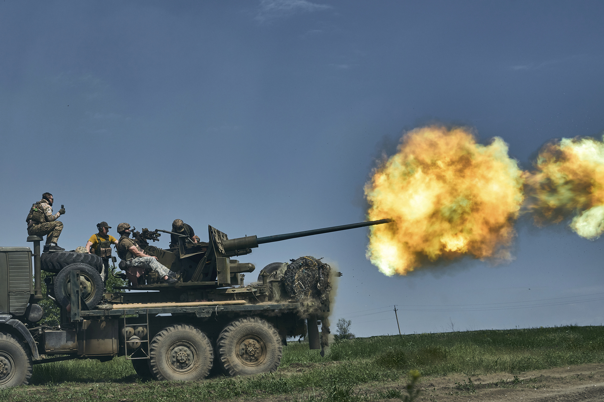 Ukrainian soldiers fire a cannon near Bakhmut in the Donetsk region, Ukraine, on May 15.