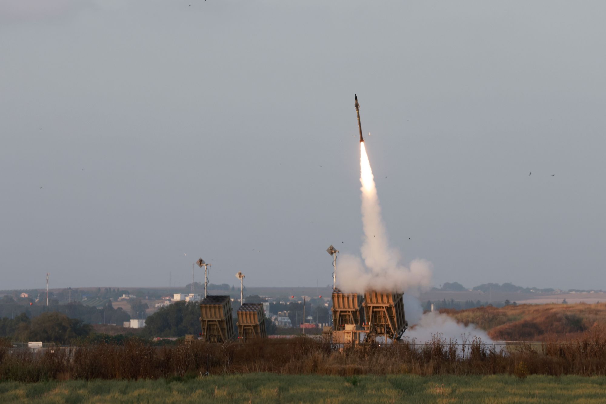 Israeli forces fire rockets from their Iron Dome defense system near the southern city of Sderot on May 13, 2023.