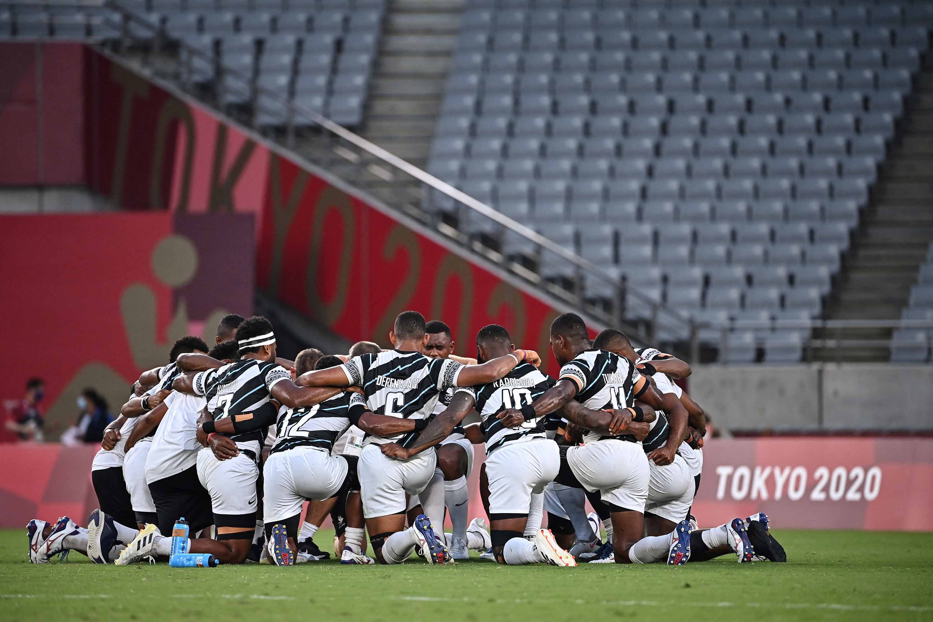 Members of Team Fiji react after winning the men's final rugby sevens match on Wednesday.