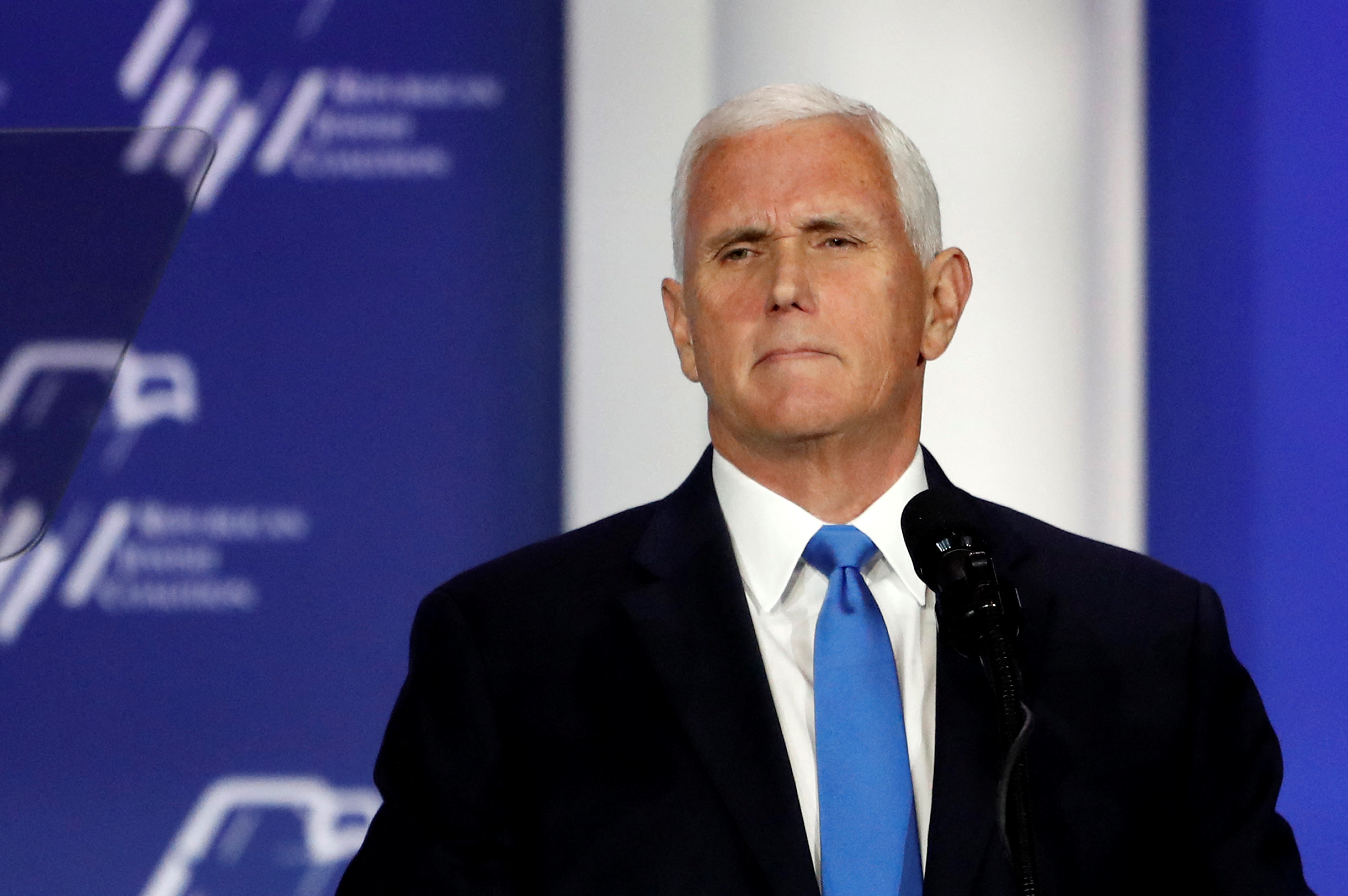 Former Vice President Mike Pence stands at the podium after suspending his presidential campaign in Las Vegas on October 28.