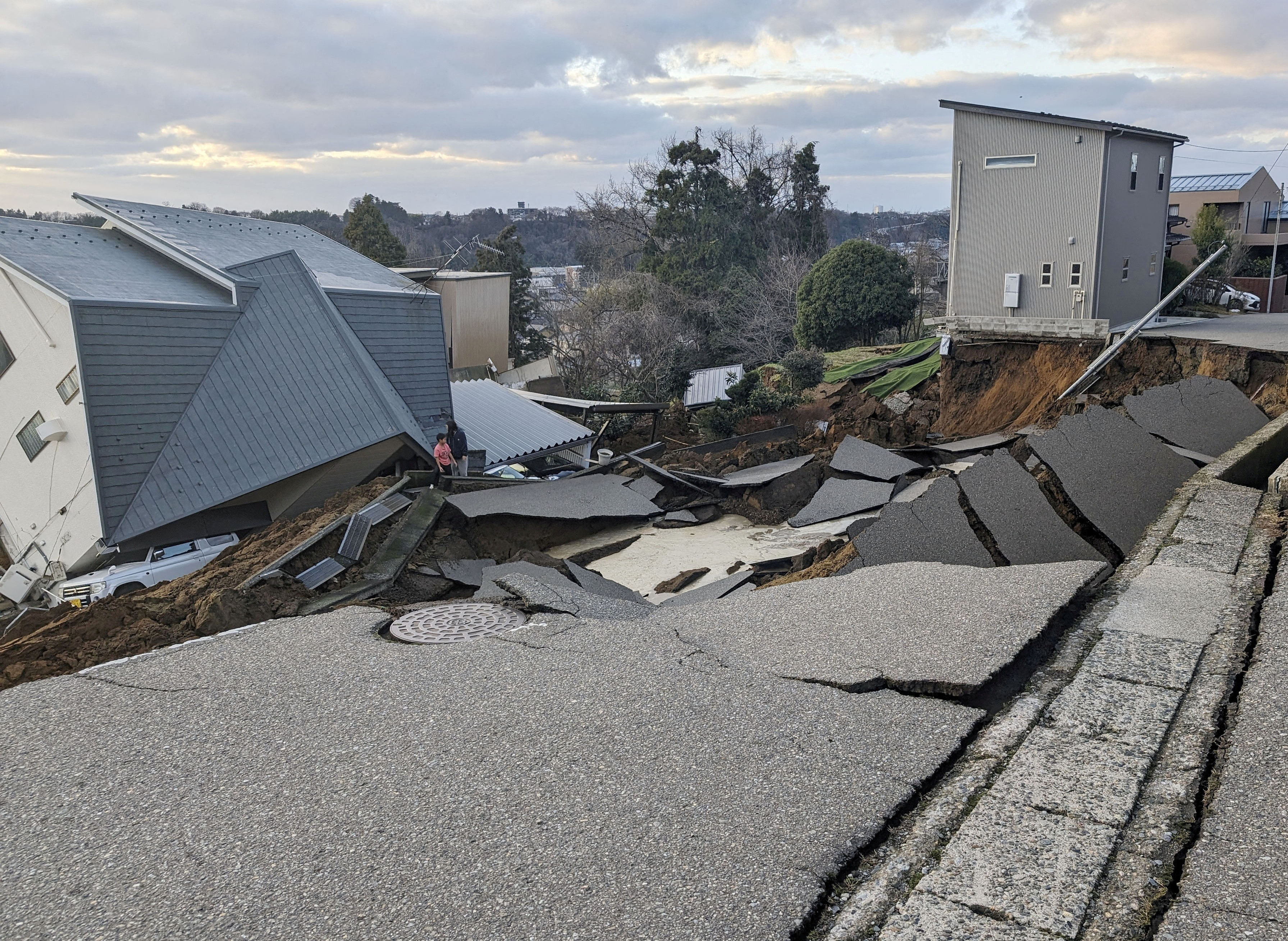 A collapsed road and houses are pictured following an earthquake in Wajima, Japan, on January 1.