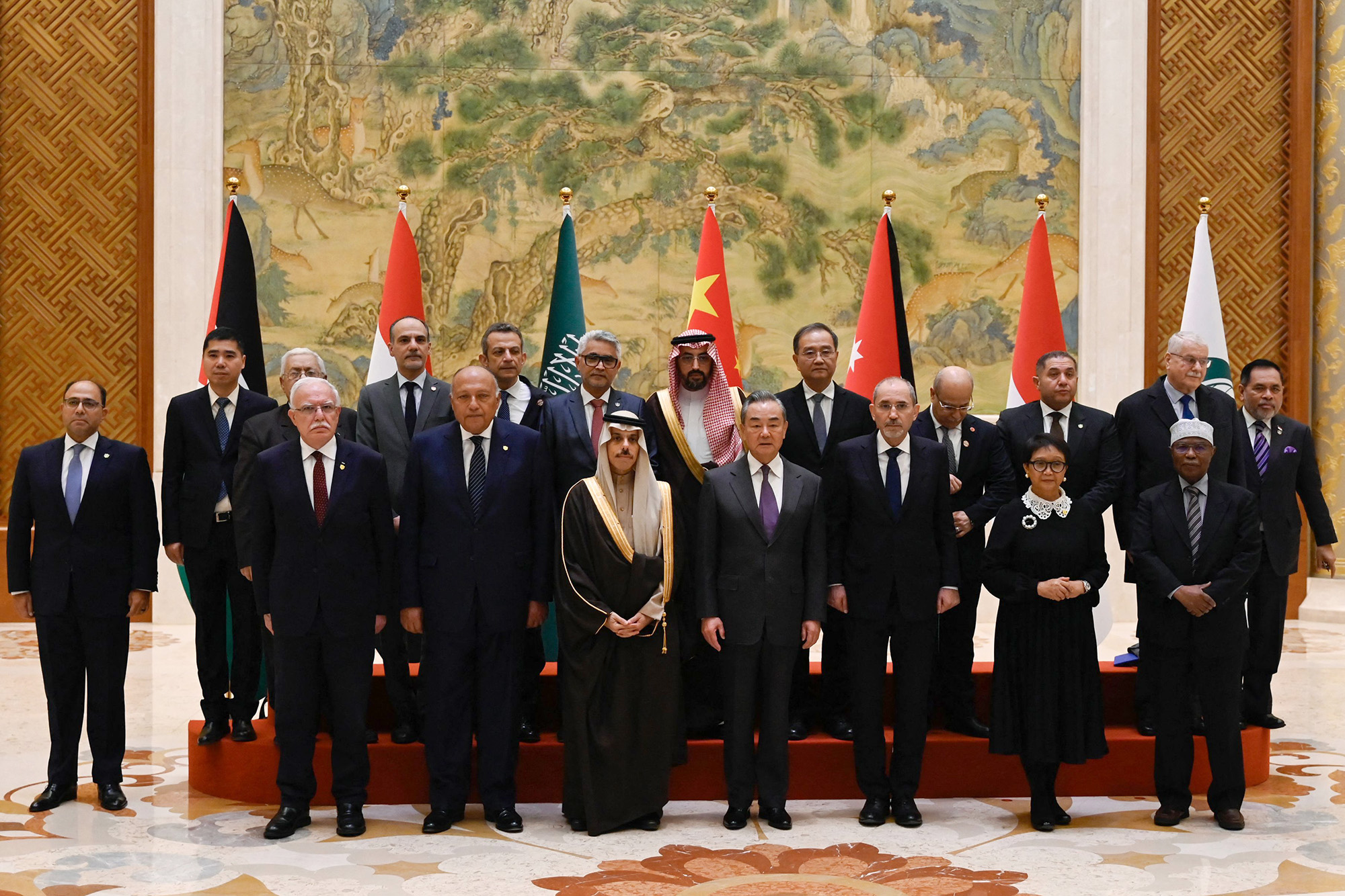 China's Foreign Minister Wang Yi (front row fourth right) poses for a group photo with officials from Saudi Arabia, Jordan, Egypt and Indonesia, as well as the Palestinian Foreign Minister and Organisation of Islamic Cooperation (OIC) Secretary-General before the meeting in Beijing on November 20.