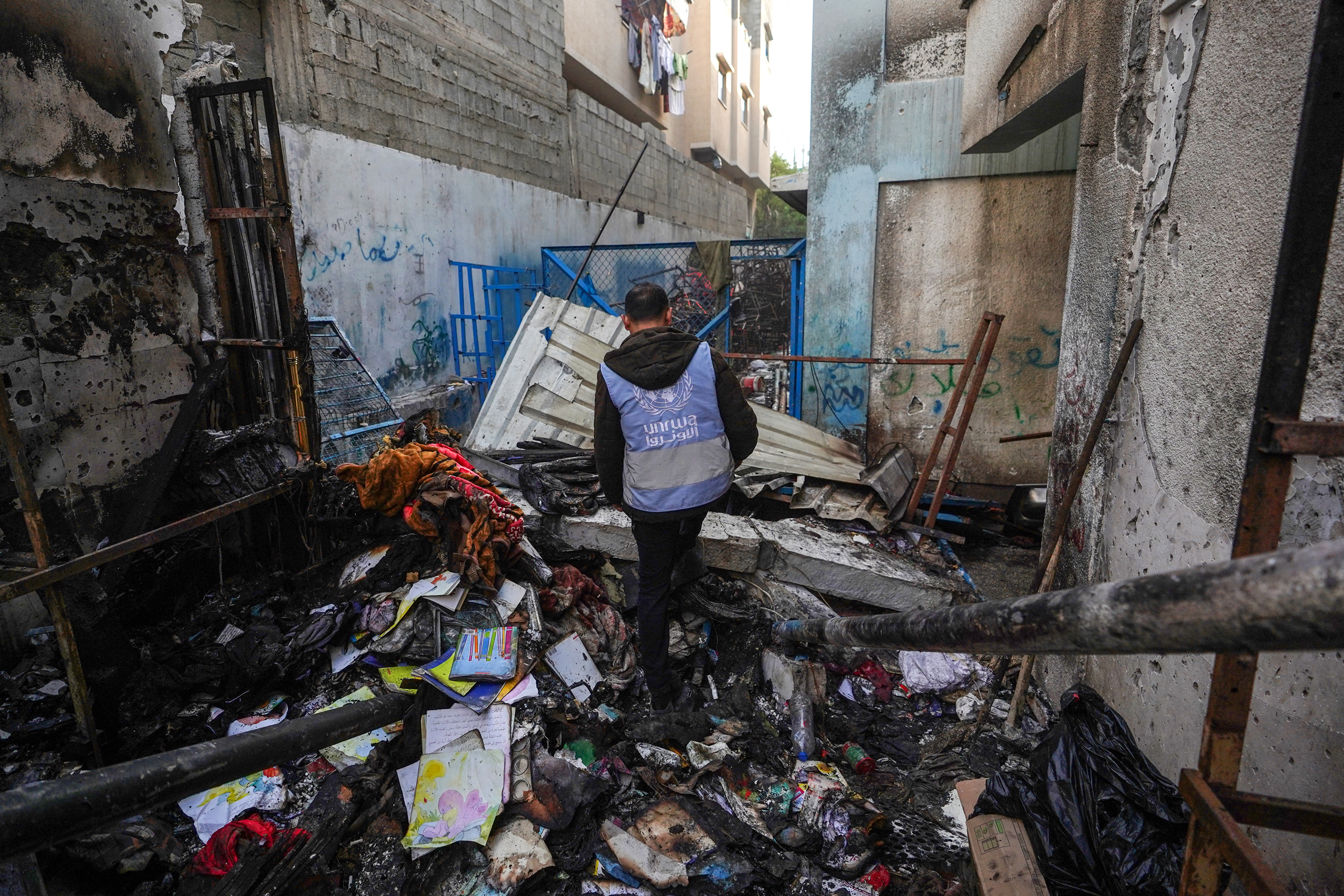 A UNRWA personnel checks a burnt area at a school housing displaced Palestinians that was hit during the ongoing conflict between Israel and the militant group Hamas, in Nuseirat in the central Gaza Strip on May 17.