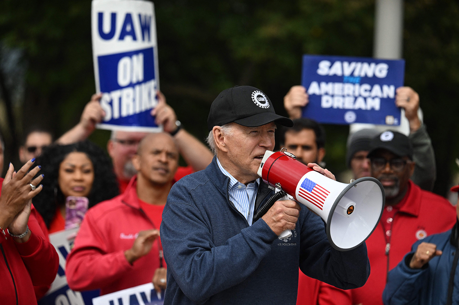 US President Joe Biden addresses striking members of the United Auto Workers (UAW) union at a picket line outside a General Motors Service Parts Operations plant in Belleville, Michigan, on September 26.