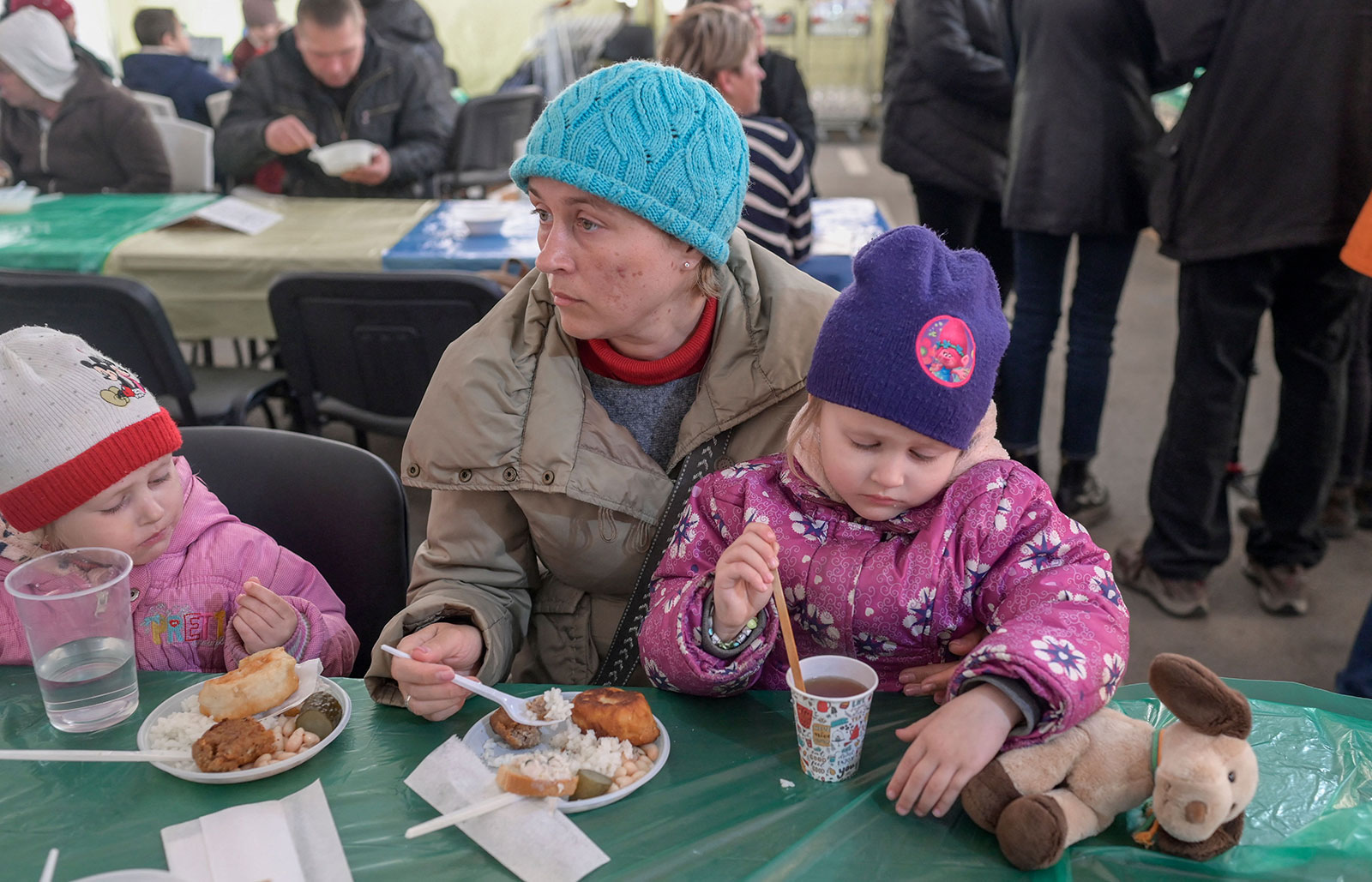 A woman and children sit for a meal after their arrival at a hub for displaced people in Zaporizhzhia on April 5. 
