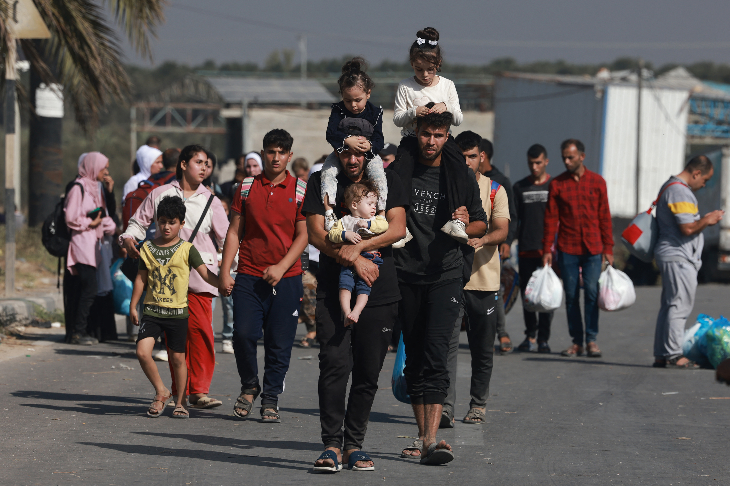 Palestinians walk down a road as they flee Gaza City and other parts of northern Gaza towards the south, on November 8.