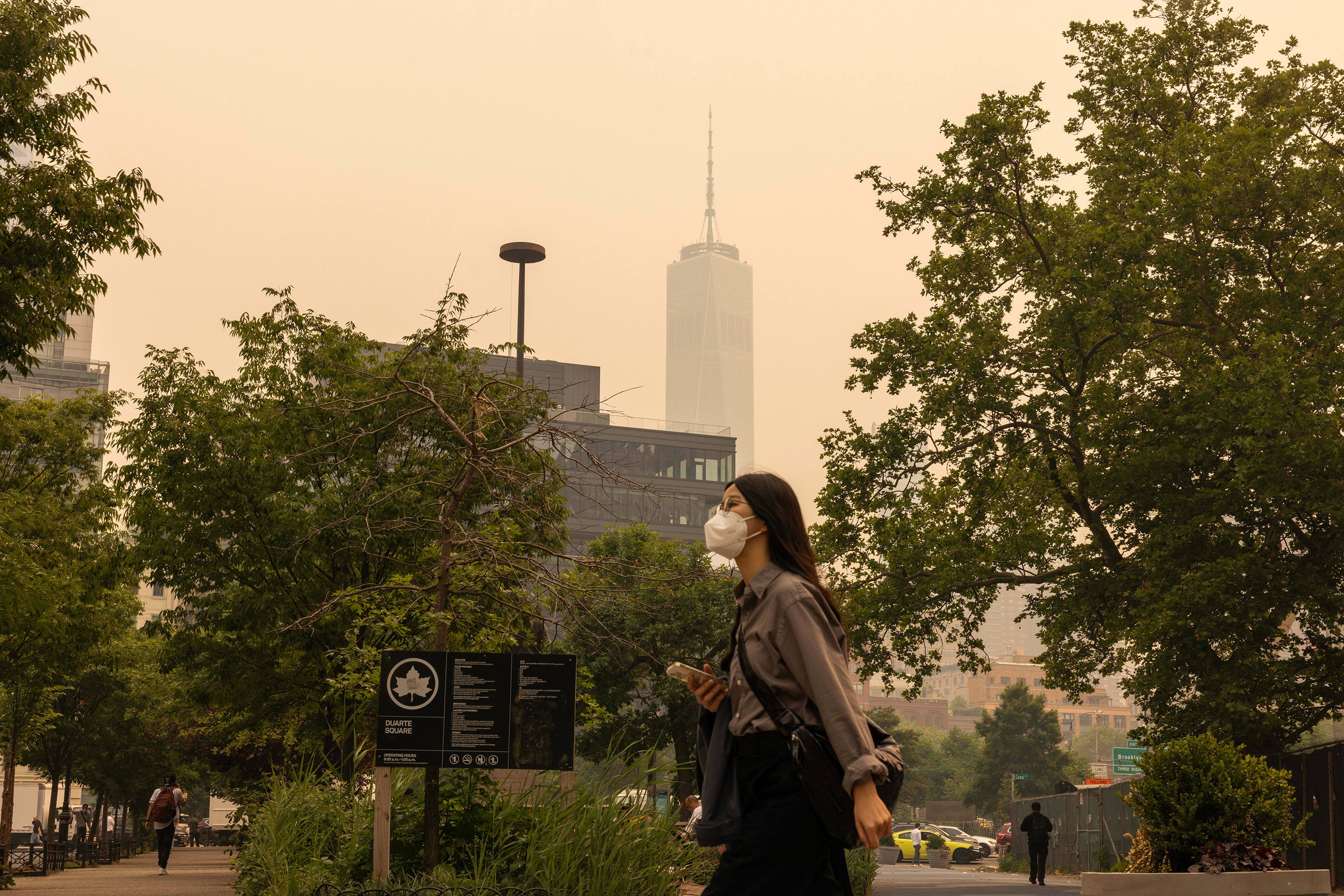 A pedestrian wears a mask as smoke from Canada wildfires blankets New York, on June 7.