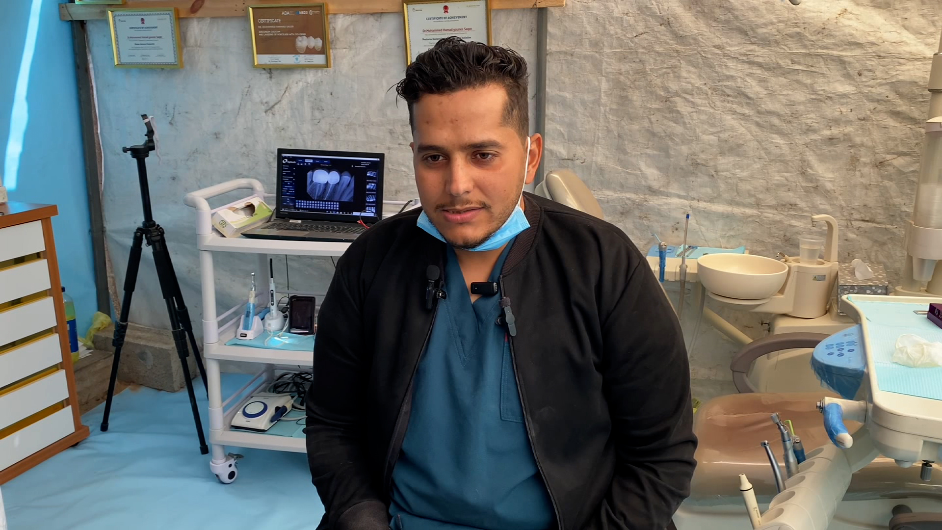 Saqer, a Palestinian dentist, opened his makeshift clinic, which is improvised with wooden poles and plastic sheeting, after Israel’s bombardment damaged his clinic.