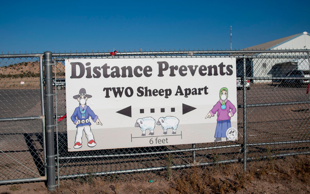 A sign encourages on September 24 social distance outside the Blue Gap Mini Store in Blue Gap, Arizona.