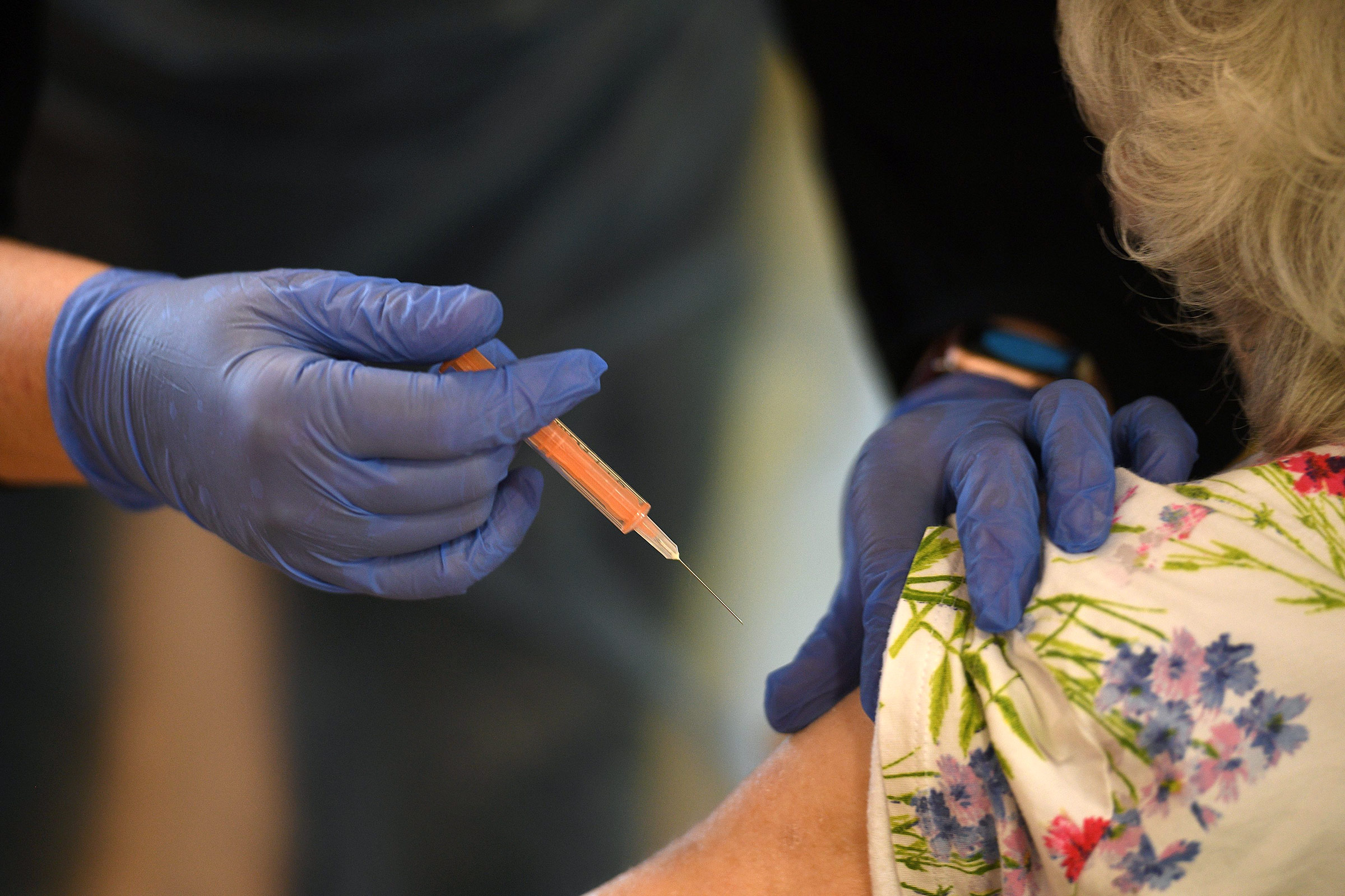 A resident receives a dose of the Oxford-AstraZeneca Covid-19 vaccine at the Belong Wigan care home in Wigan, England, on January 21. 