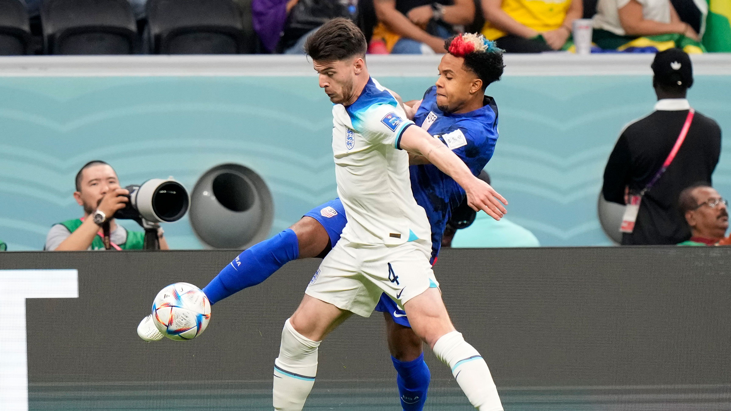 England's Declan Rice, in white, tries to shield the United States' Weston McKennie at the start of Friday's match.