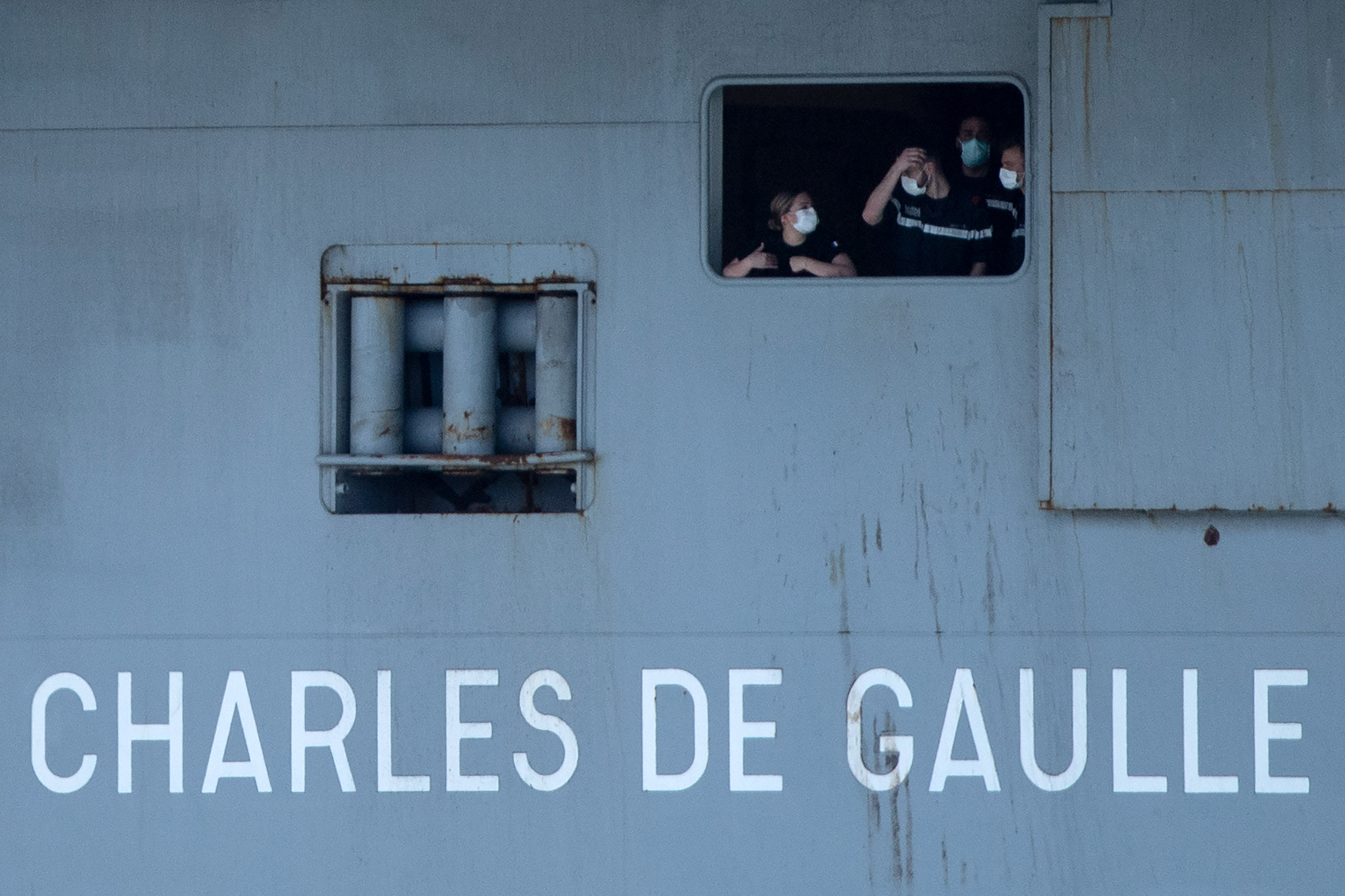 French navy soldiers stand onboard the French aircraft carrier the Charles de Gaulle as it arrives in the southern port of Toulon in France on April 12.