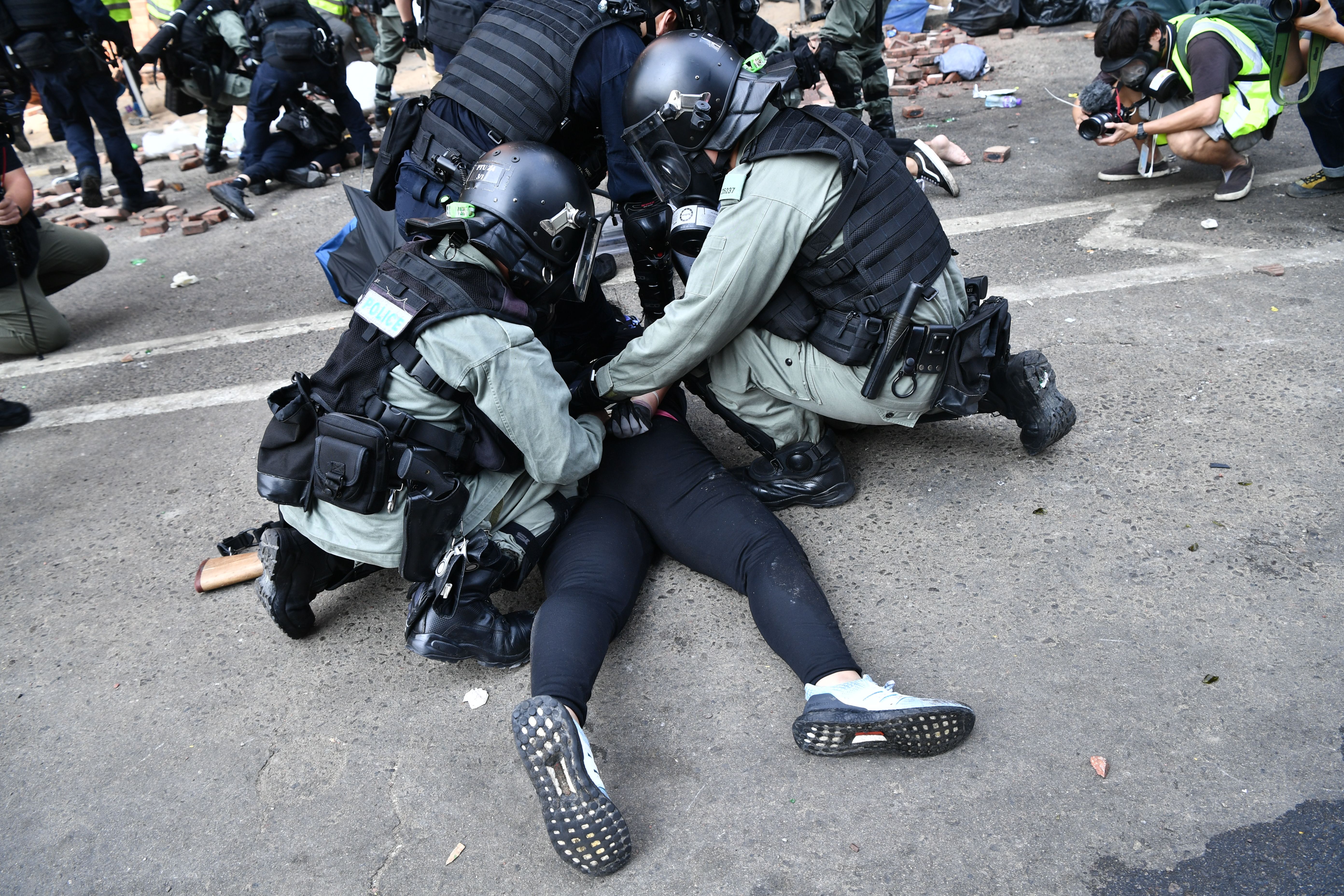 Police tackle protesters near the Hong Kong Polytechnic University on November 18, 2019.