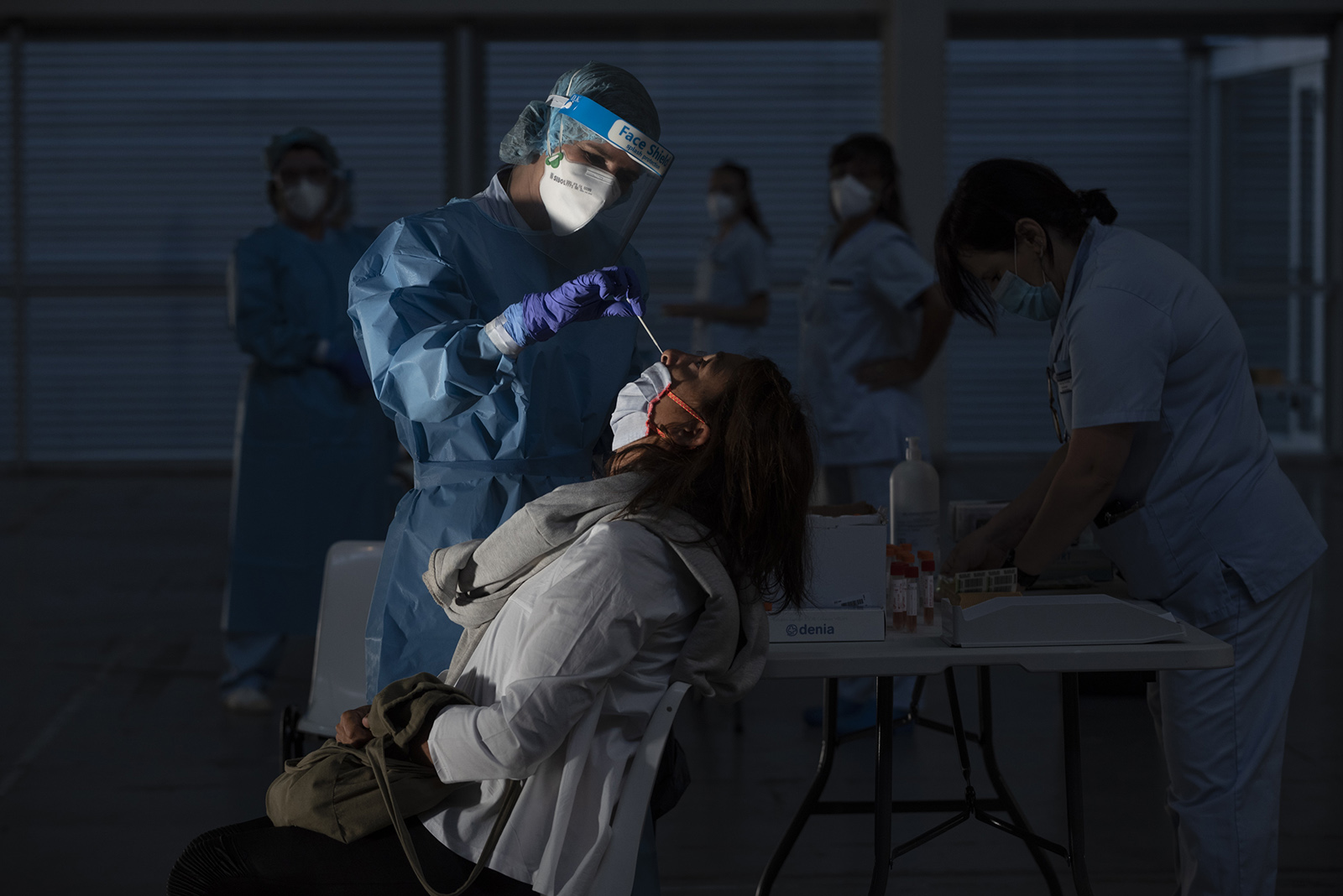 A health worker does a PCR test on a patient at Ficoba exhibition site, where mass coronavirus tests are being carried out on September 3, 2020 in Irun, Spain. 