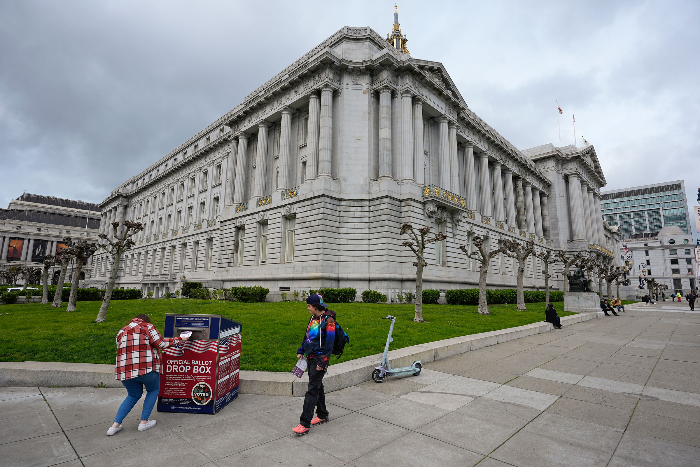 People drop off their ballots at a drop box outside City Hall in San Francisco, on Tuesday. 