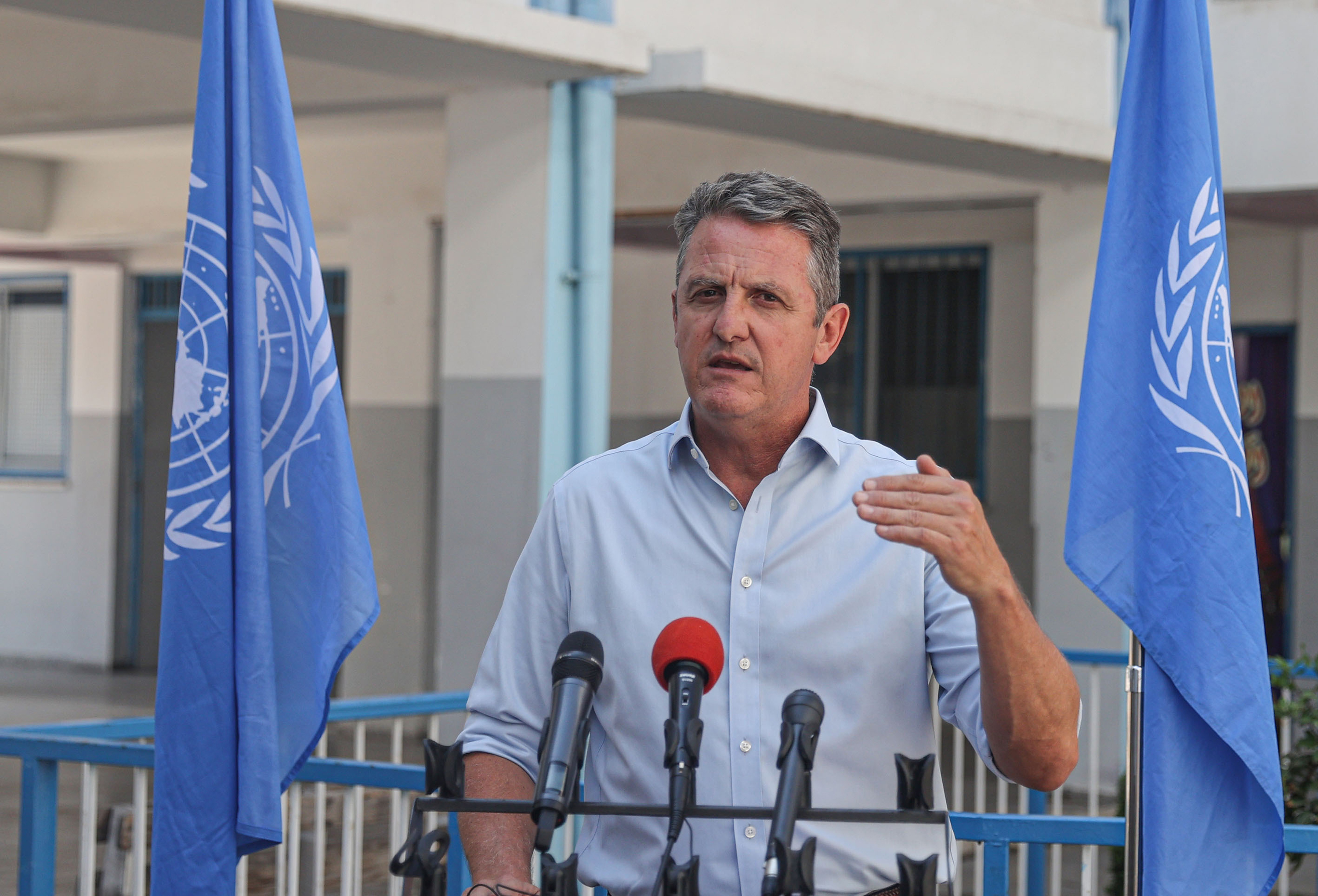 Thomas White speaks to press as he visits a UNRWA school in Gaza City, on August 27.