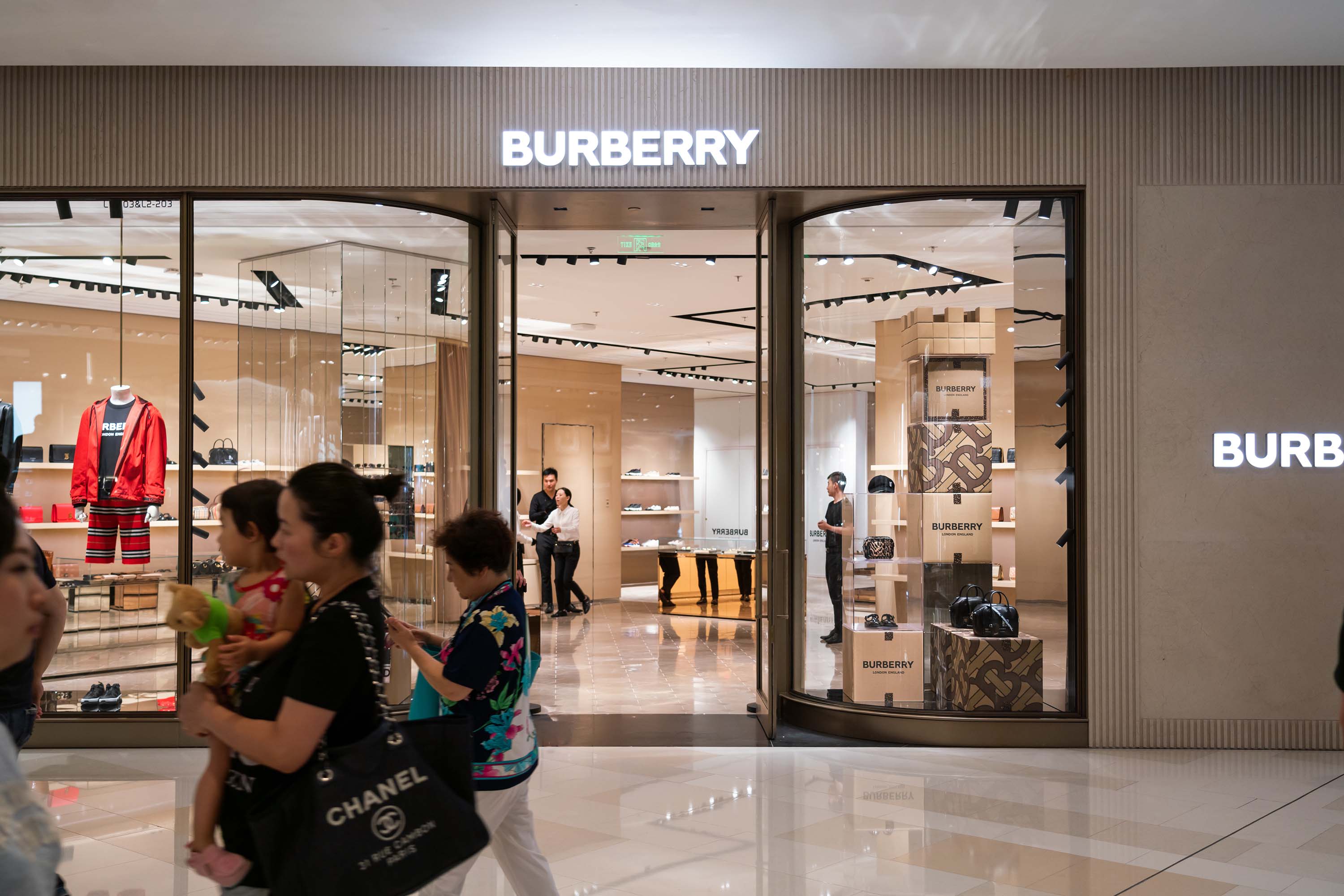 Pedestrians walk past a Burberry store in Shanghai in July 2019.