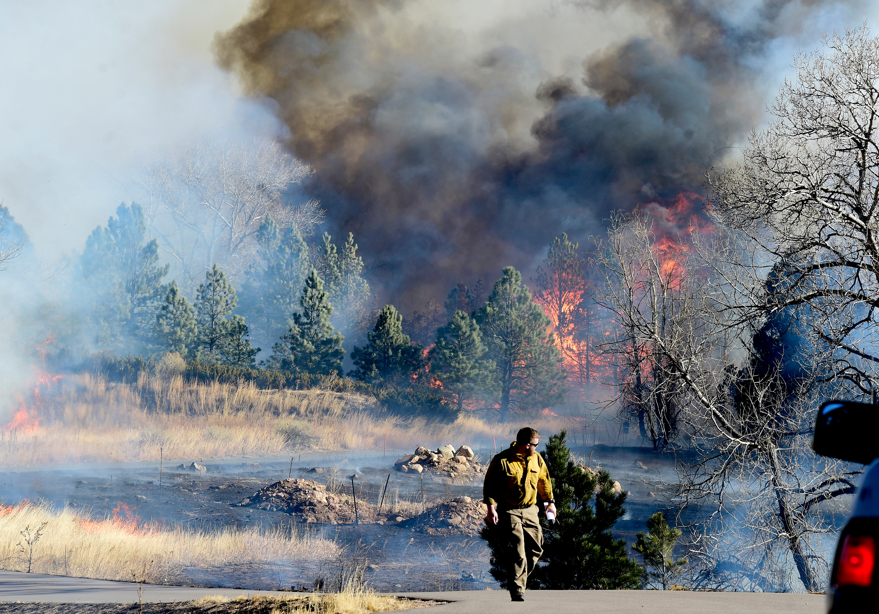 A firefighter walks near a fire north of Boulder, Colorado, on Thursday, December 30. 