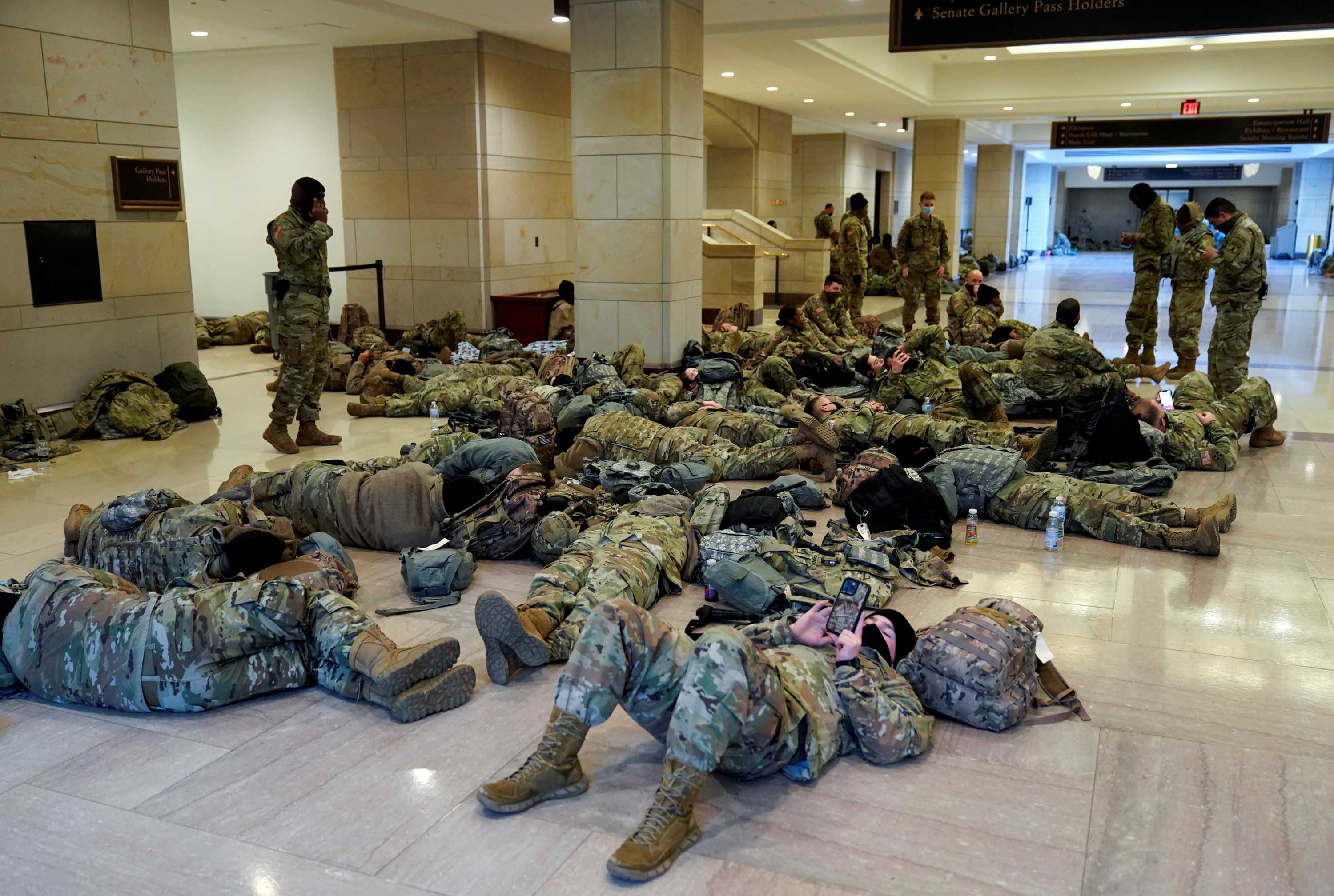 National Guard members rest in the Capitol Vistor's Center, ahead of the debate on impeachment against US President Trump on January 13.