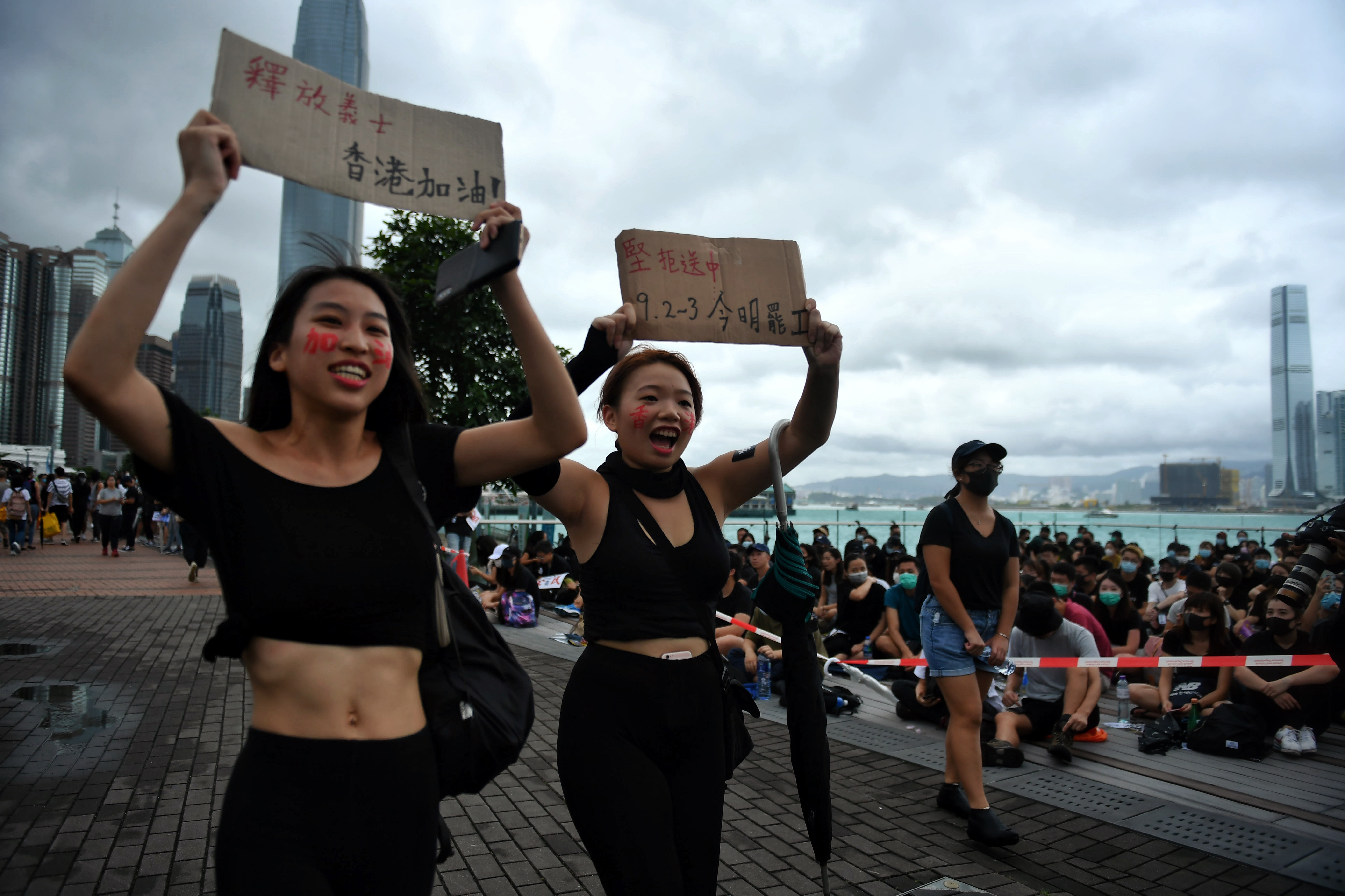 Protesters hold placards during a rally at Tamar Park. Thousands of black-clad students rallied on September 2 at the start of a two-week boycott of university classes, piling pressure on Hong Kong's leaders to resolve months of increasingly violent anti-government protests that show no sign of easing.