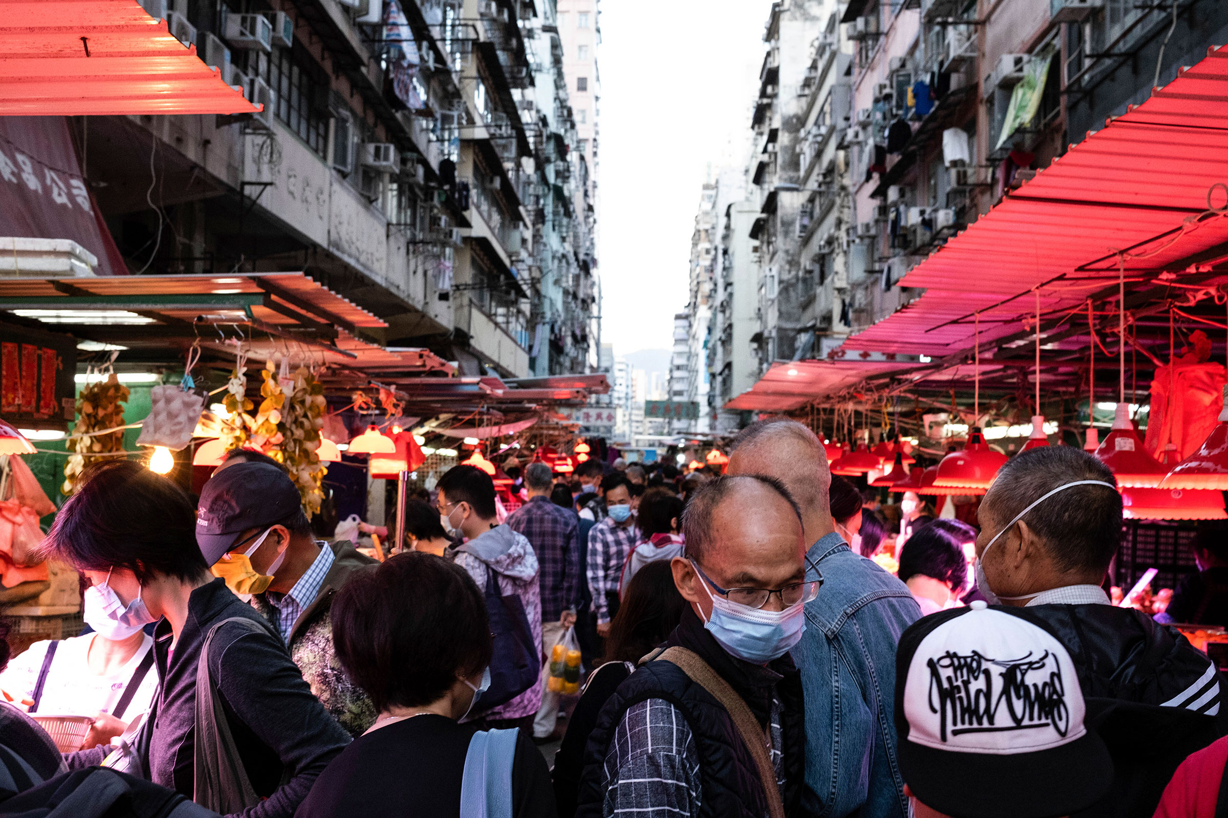 People shop at a crowed street market on December 3 in Hong Kong.