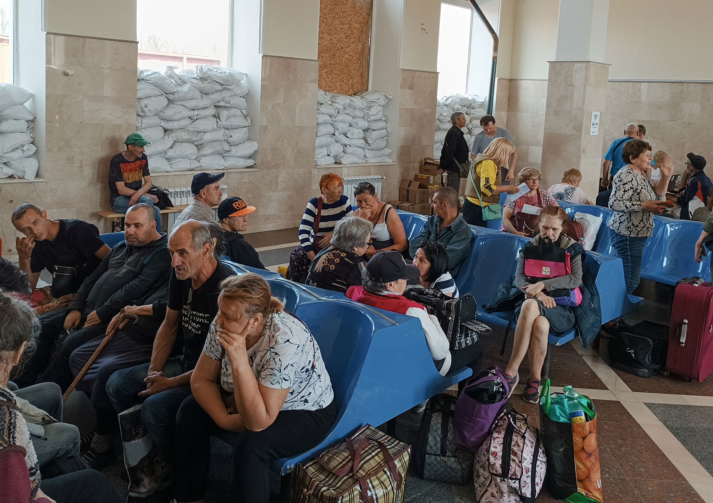Local residents wait for an evacuation train, amid Russia's attack on Ukraine, at a railway station in Kherson, Ukraine, on June 6.