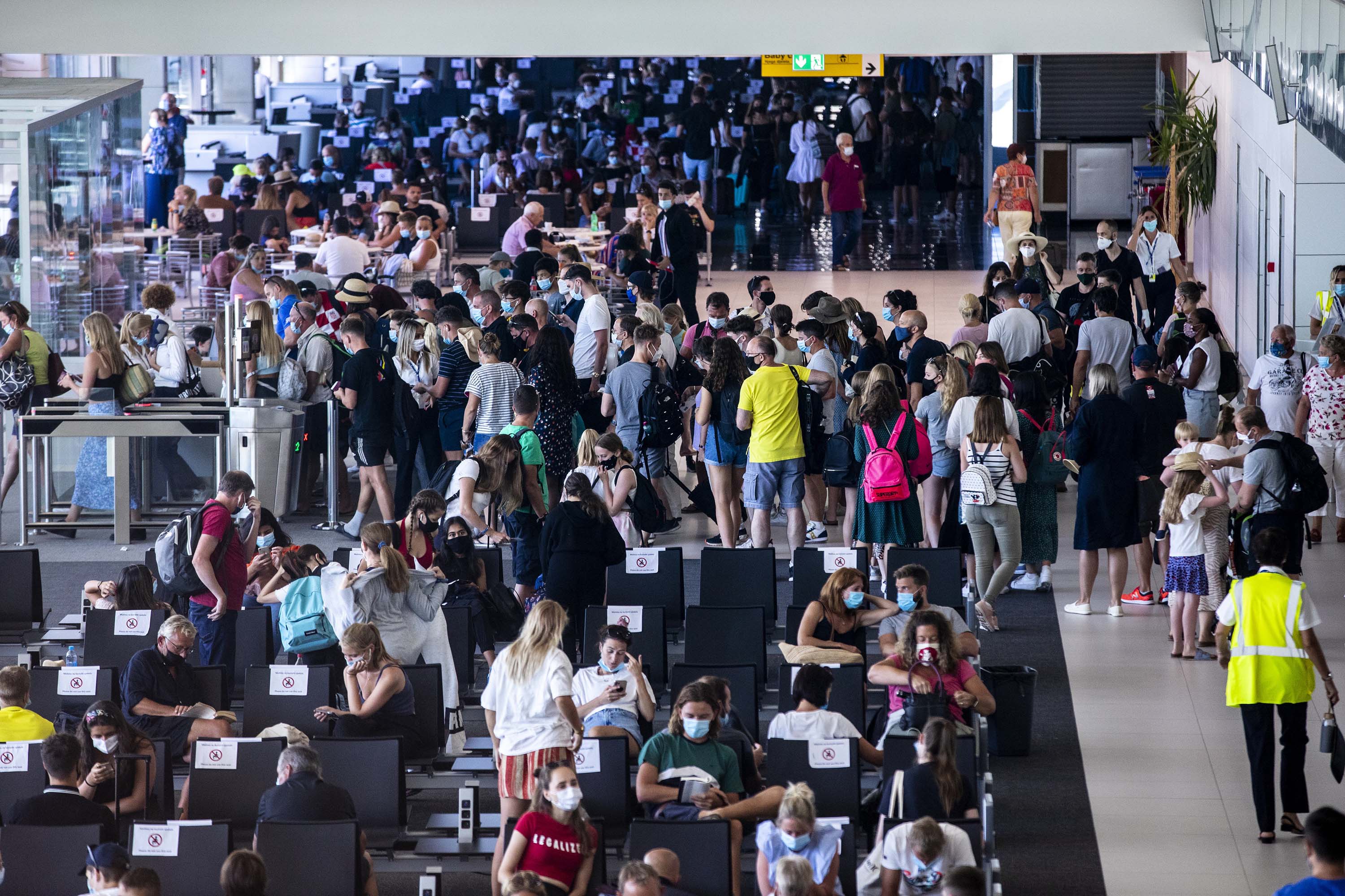 People are seen at Split International Airport after the United Kingdom removed Croatia from a list of "safe countries" to travel on August 20, due to the rising number of cases throughout the country.