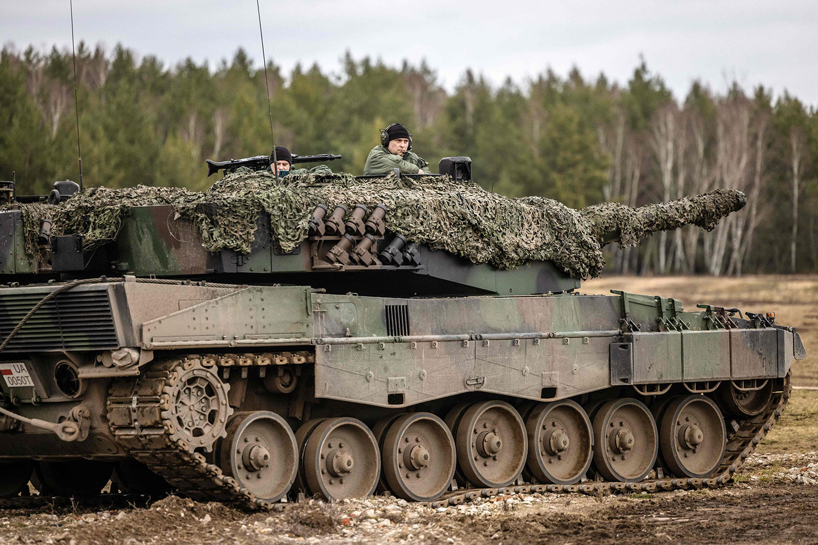 Polish and Ukrainian soldiers are seen on a Leopard 2 A4 tank during training at the Świętoszów Military Base in western Poland on Monday. 