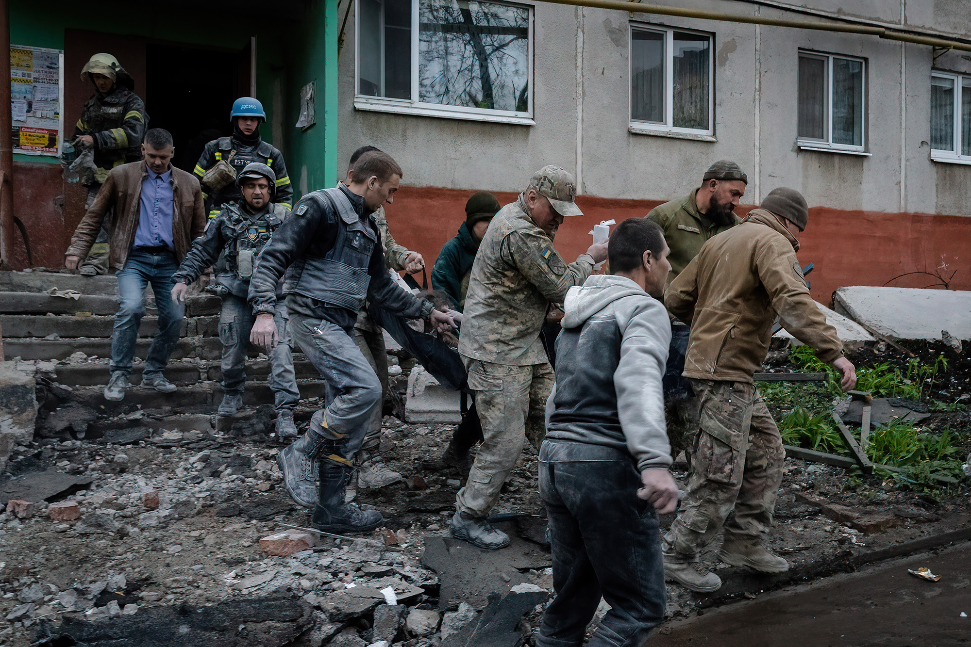 Military officials and firefighters rescue people following a rocket attack in Sloviansk, Ukraine, on April 14. 
