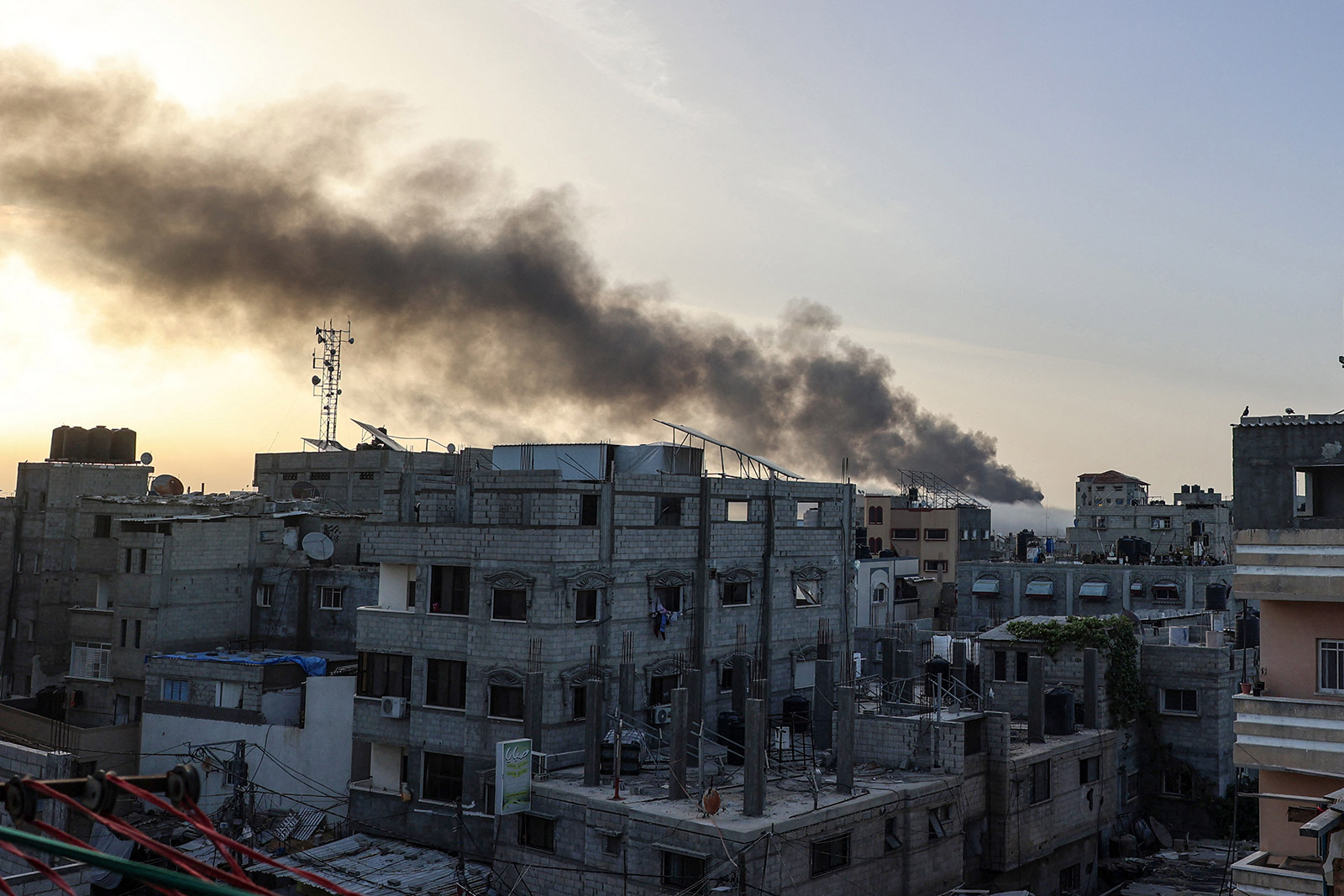 Smoke rises above building at sunrise, in the aftermath of Israeli bombardment in Rafah in the southern Gaza Strip on May 10, 2024
